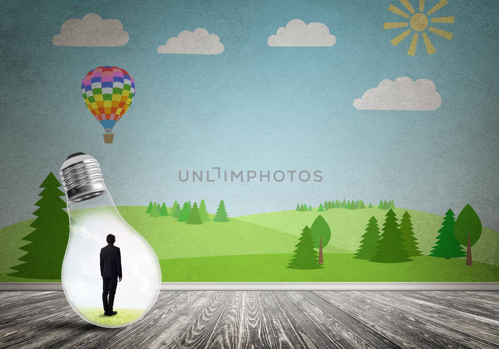 Businessman inside light bulb in room against nature drawn concept