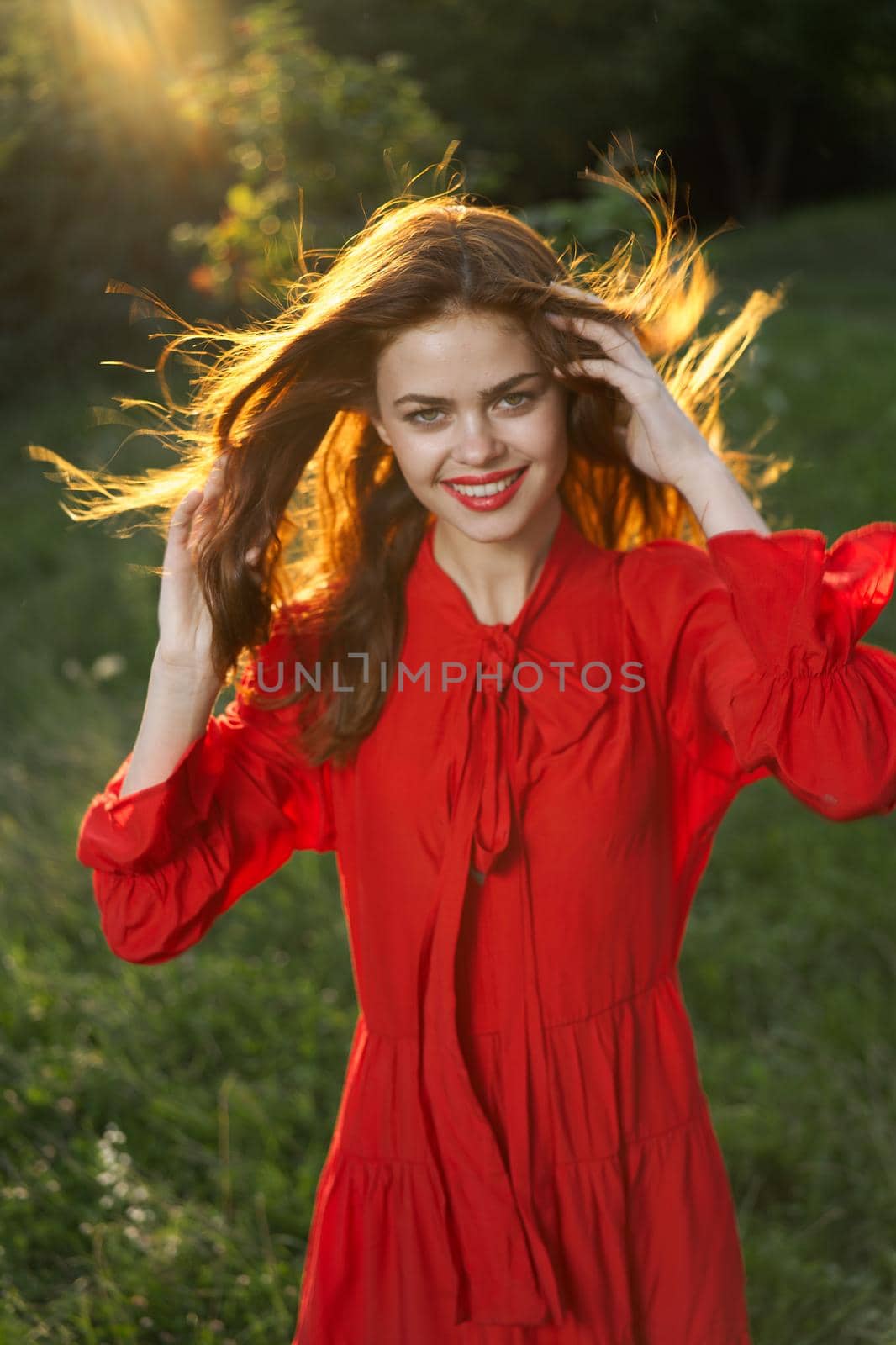 woman in red dress posing nature sun fun. High quality photo