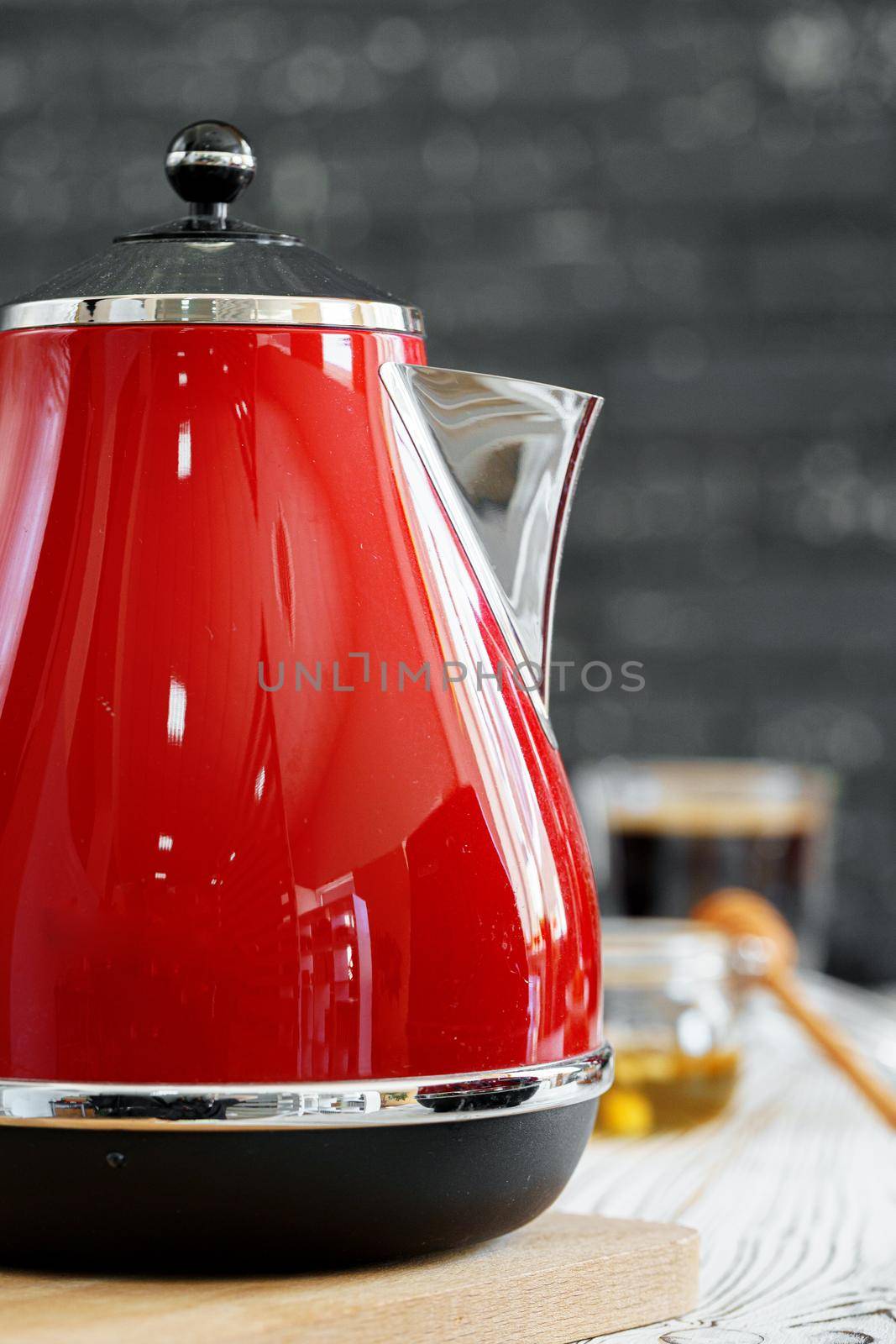 Red kettle on kitchen counter table close up