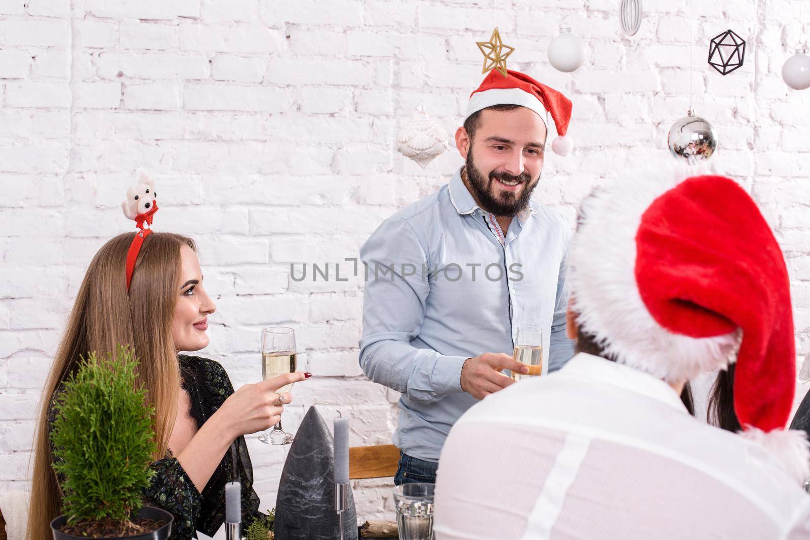Christmas party cheerful friends at having drink and fun by nazarovsergey