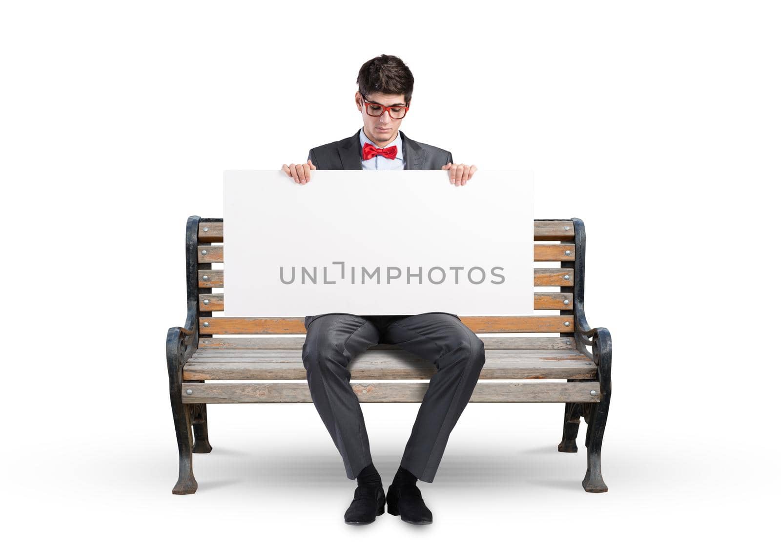 Young businessman holds a large white banner. sits on the bench