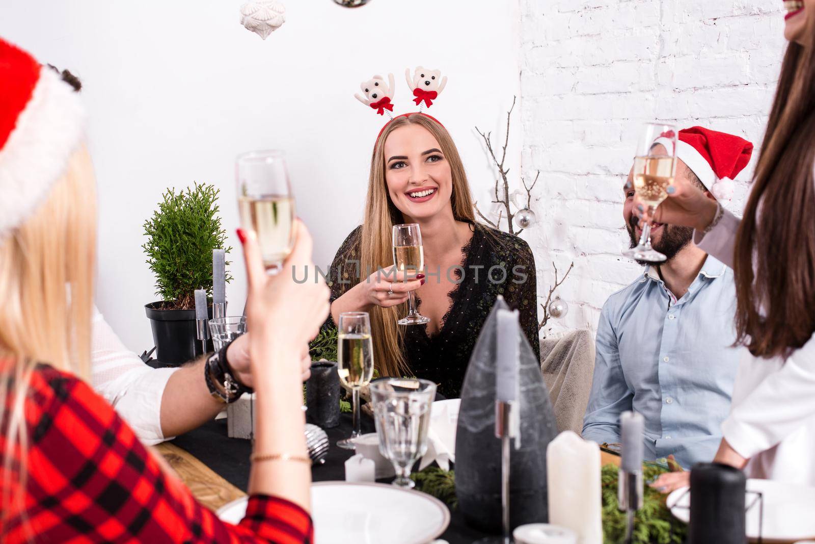 Christmas party cheerful friends at having drink and fun by nazarovsergey