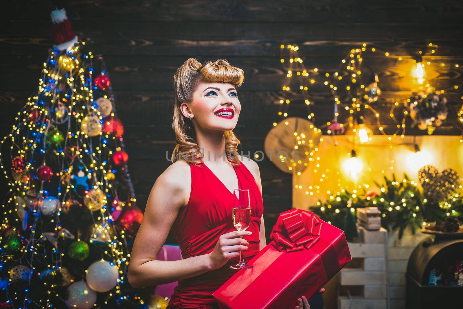 Fashion woman in Christmas dress near the Christmas tree. Christmas preparation luxury girl celebrating new year