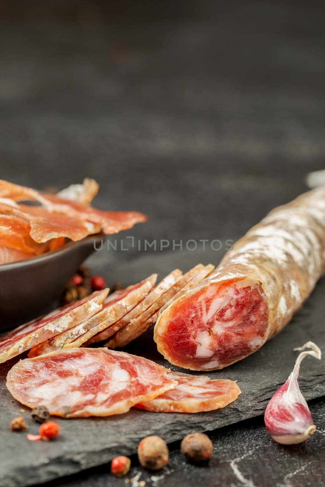 Traditional smoke dried pork sausage on a board by Syvanych