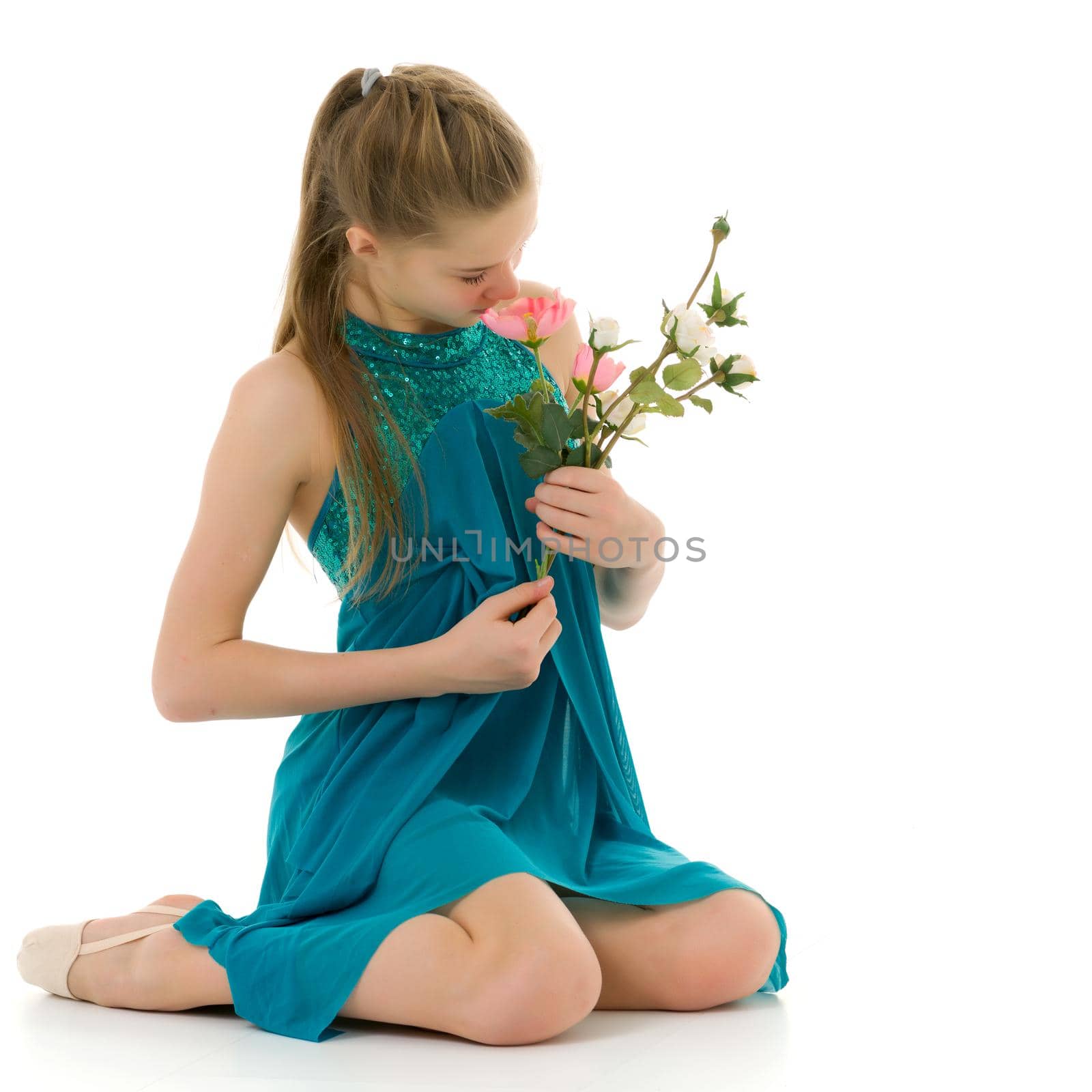 Adorable little girl in a beautiful dress posing in the studio with a cute bouquet of roses. The concept of a happy childhood, holiday. isolated on a white background.