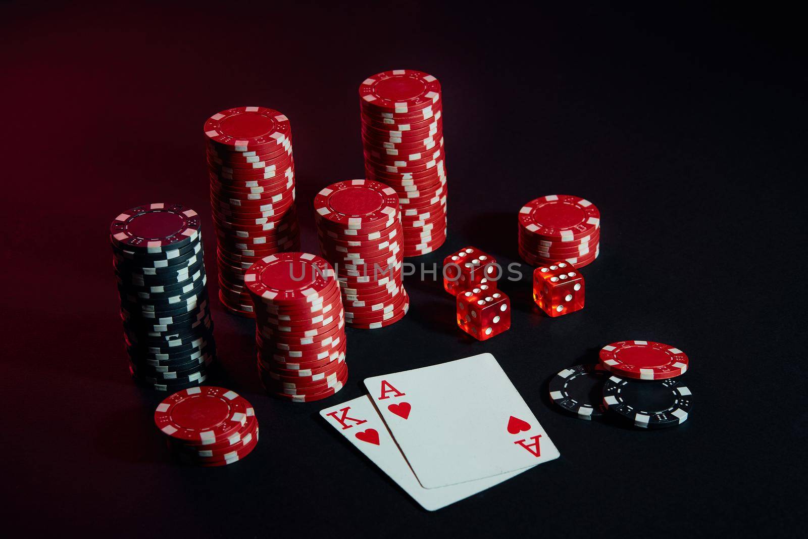 Stack of chips and two cards on dark background - poker game concept. Still life. Copy space. Poker Online. Cards - Ace and King