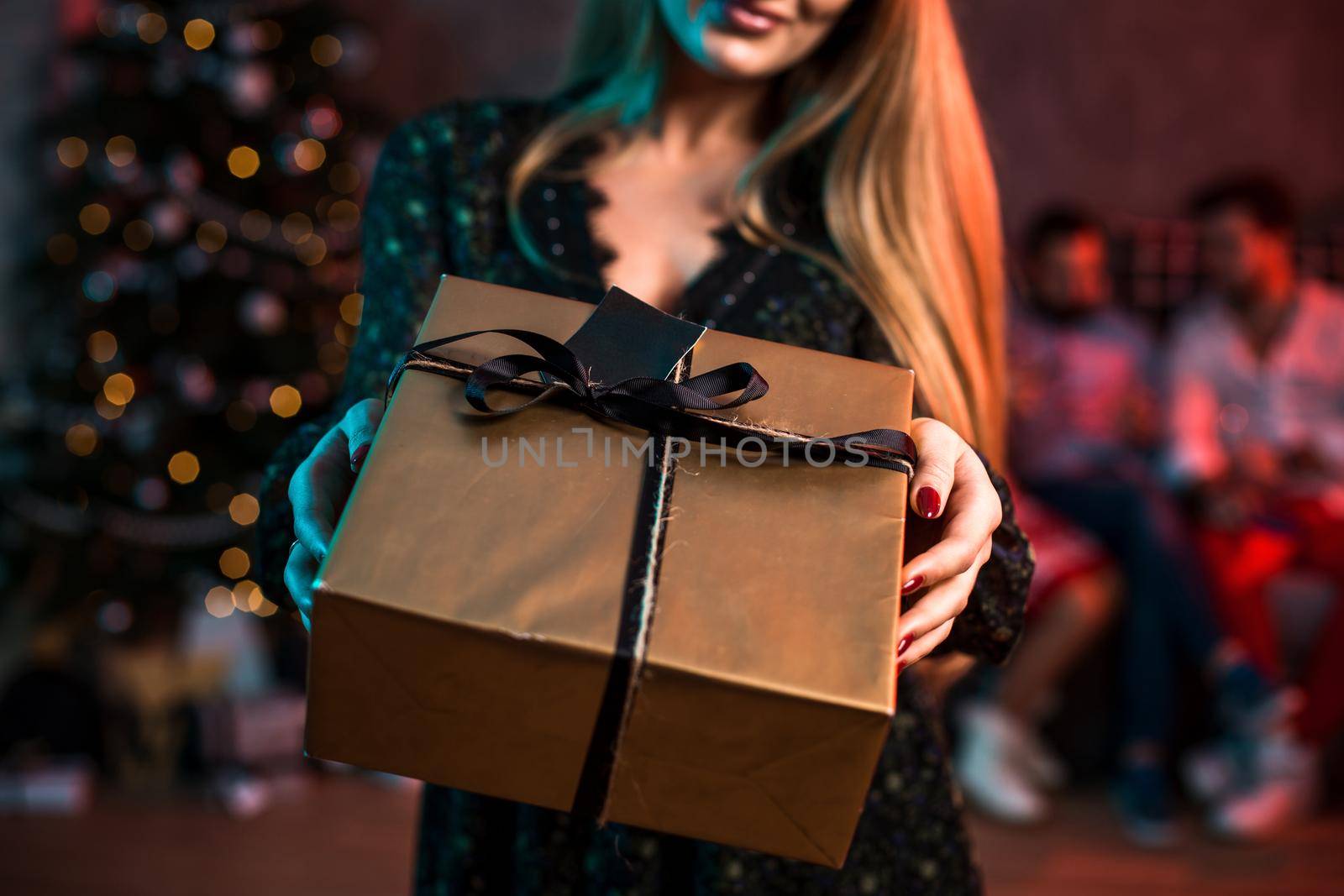 Christmas, x-mas, New year, winter, happiness concept - smiling woman with gift box. Funny people. Christmas party at home