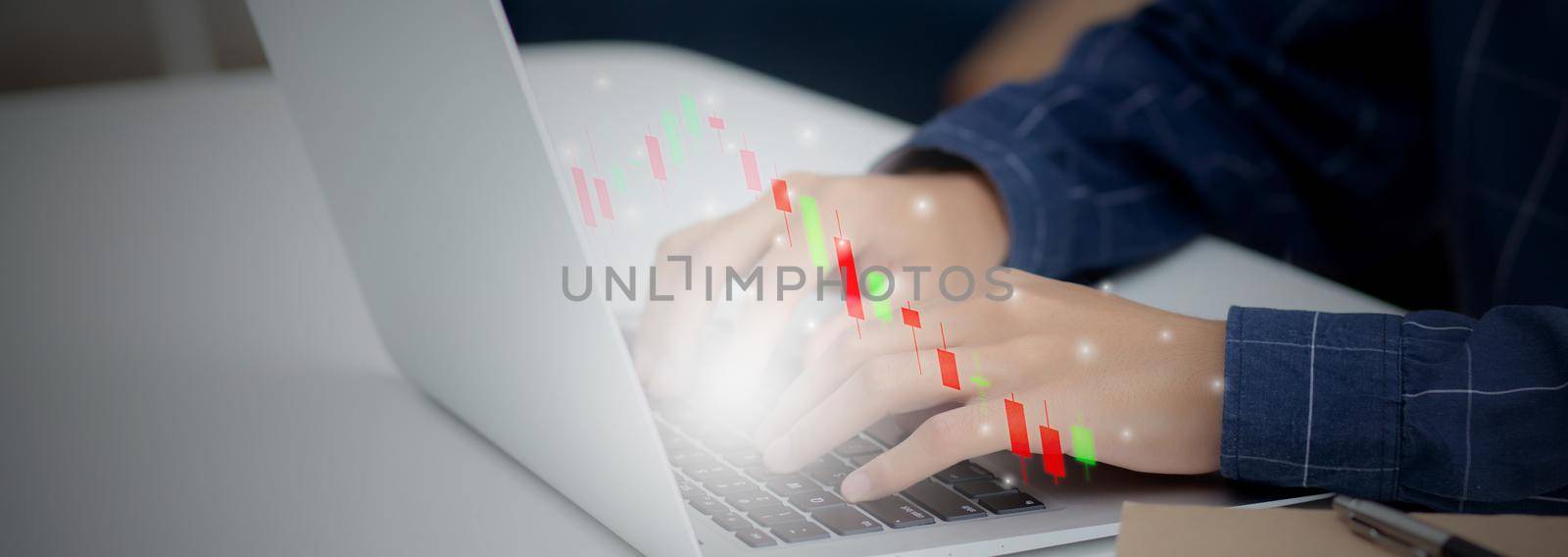 Hands of businessman using laptop computer having graph of investment with risk stock and funds virtual on desk, marketing for strategy and planning for success, business futuristic concepts.