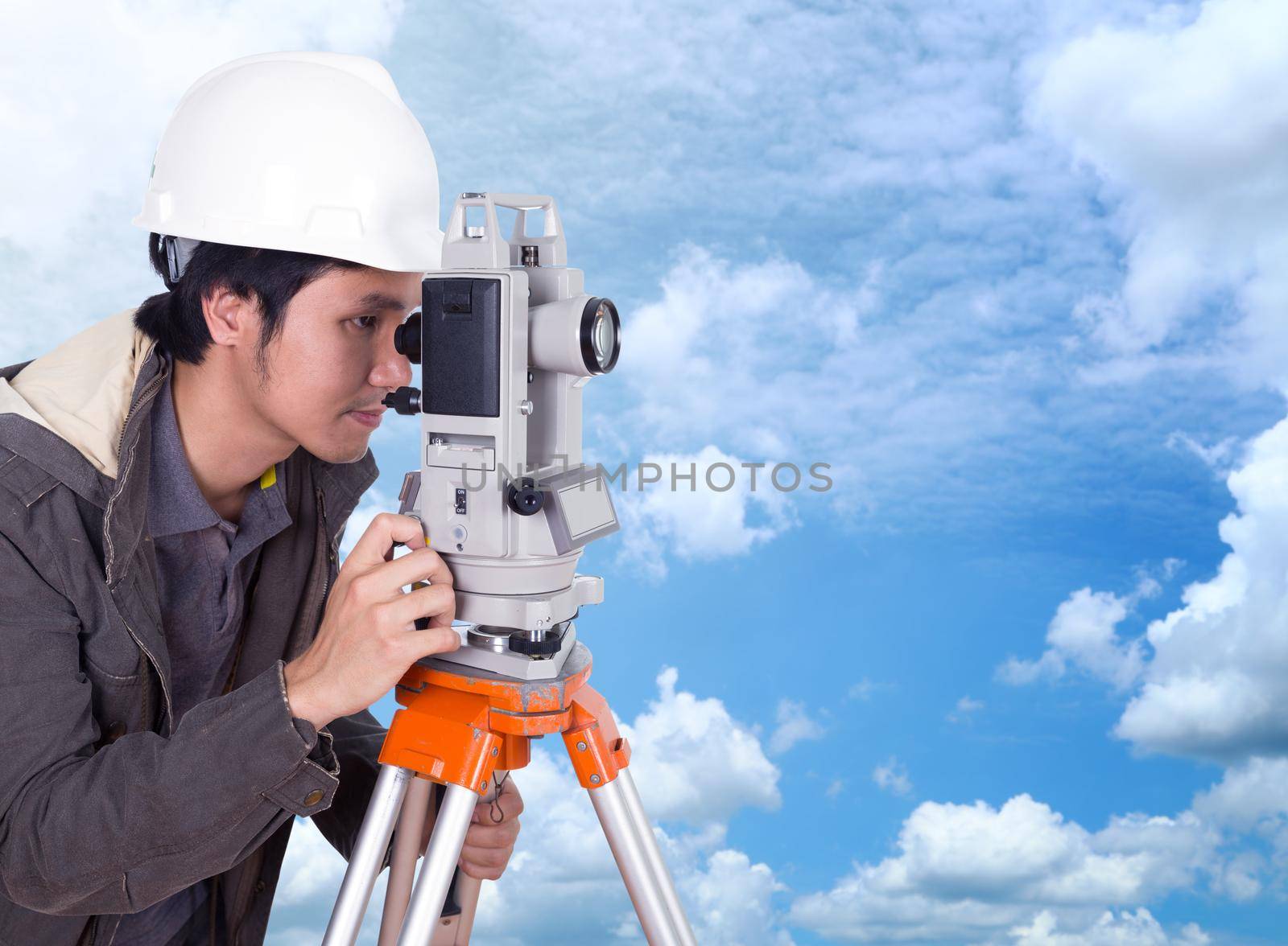 engineer working with survey equipment theodolite with blue sky by geargodz