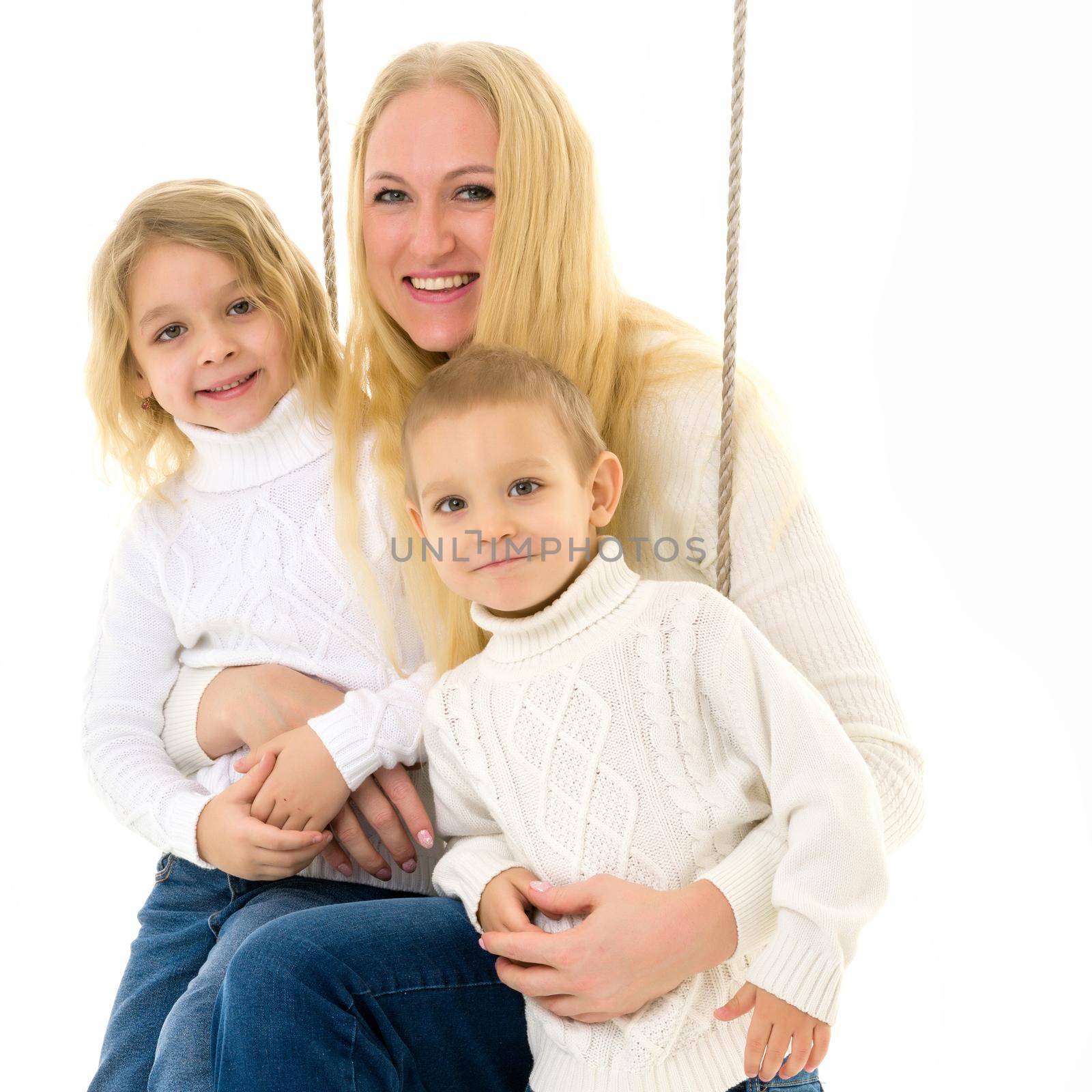 Happy Family of Mother and Two Kids Sitting Together on Rope Swing by kolesnikov_studio