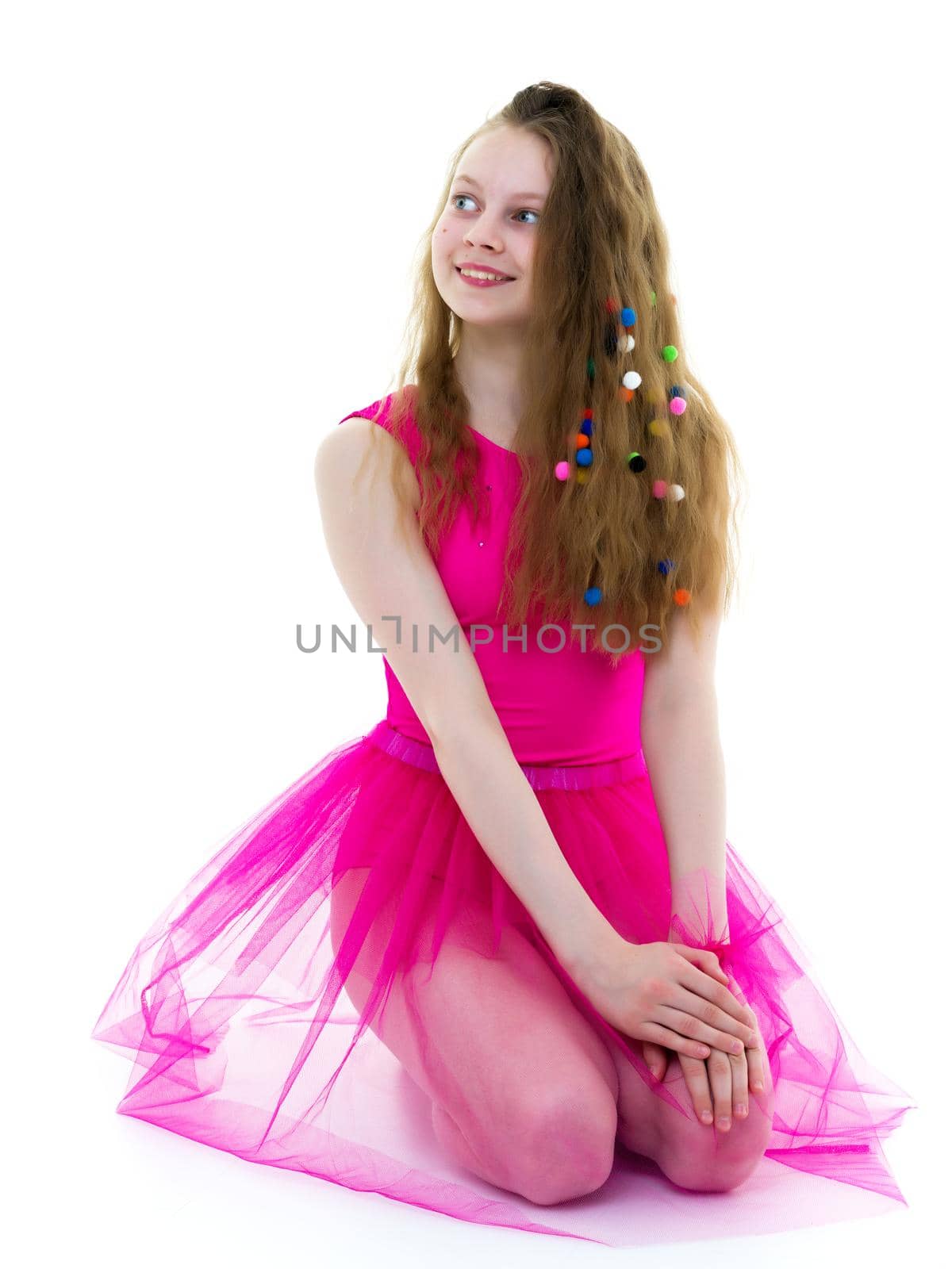 Girl gymnast school age with long silky hair in which scattered multi-colored confetti. The concept of sport and fashion. Isolated on white background.