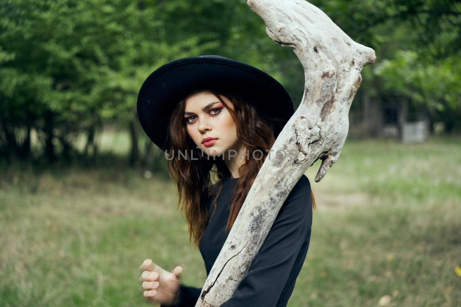 woman in black witch costume in forest nature posing by Vichizh