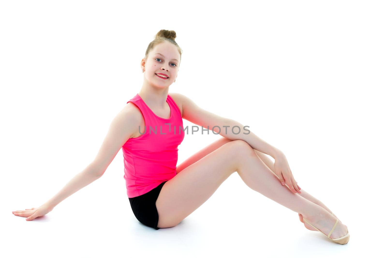 A gymnast girl prepares for the exercise. The concept of childhood and sport, a healthy lifestyle. Isolated on white background.