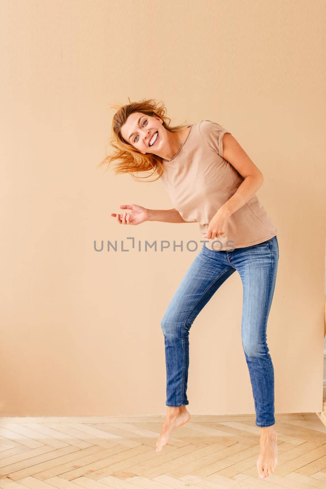 Portrait of a joyful young woman jumping by Demkat