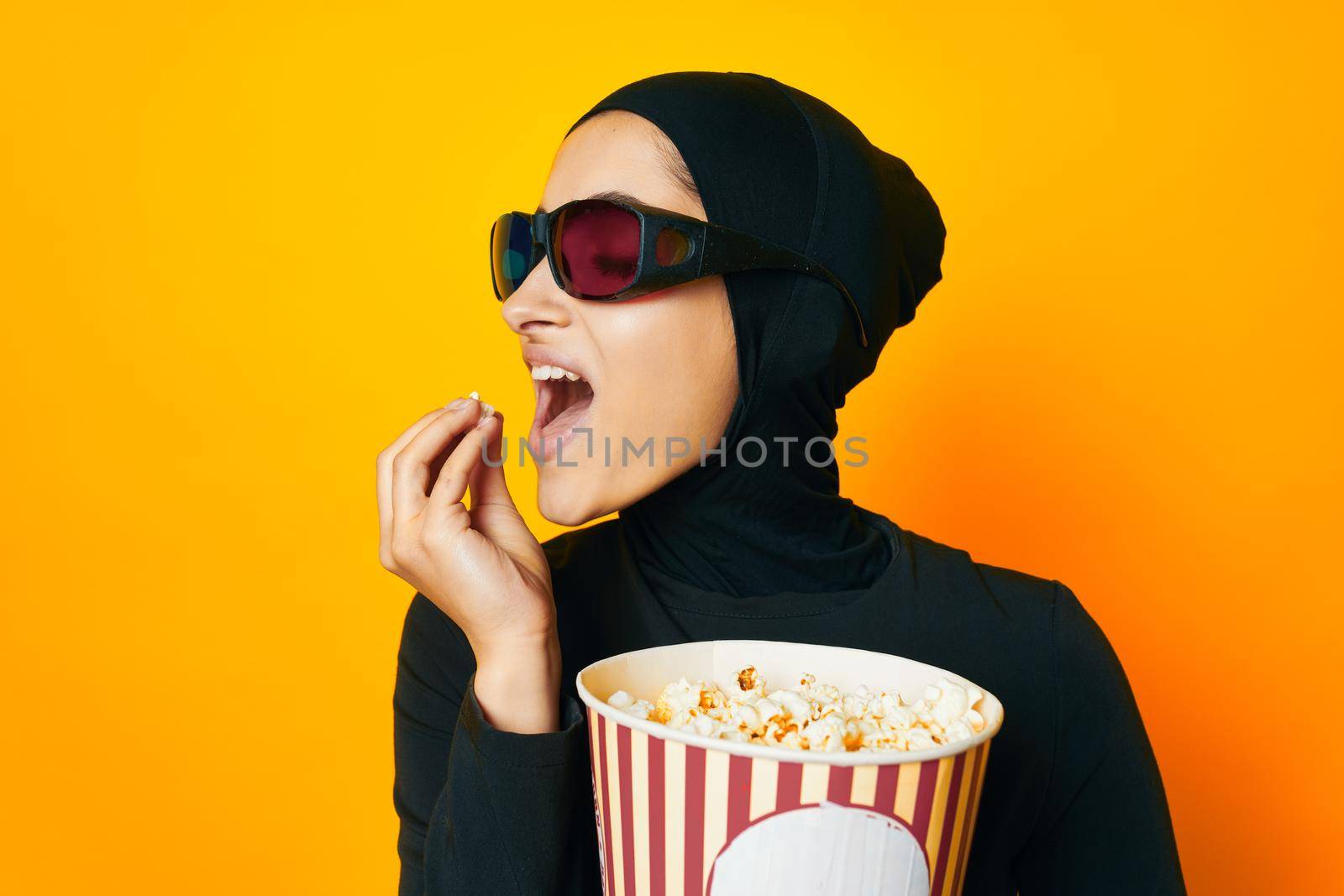 cheerful woman in black hijab popcorn 3D glasses cinema ethnicity model by Vichizh