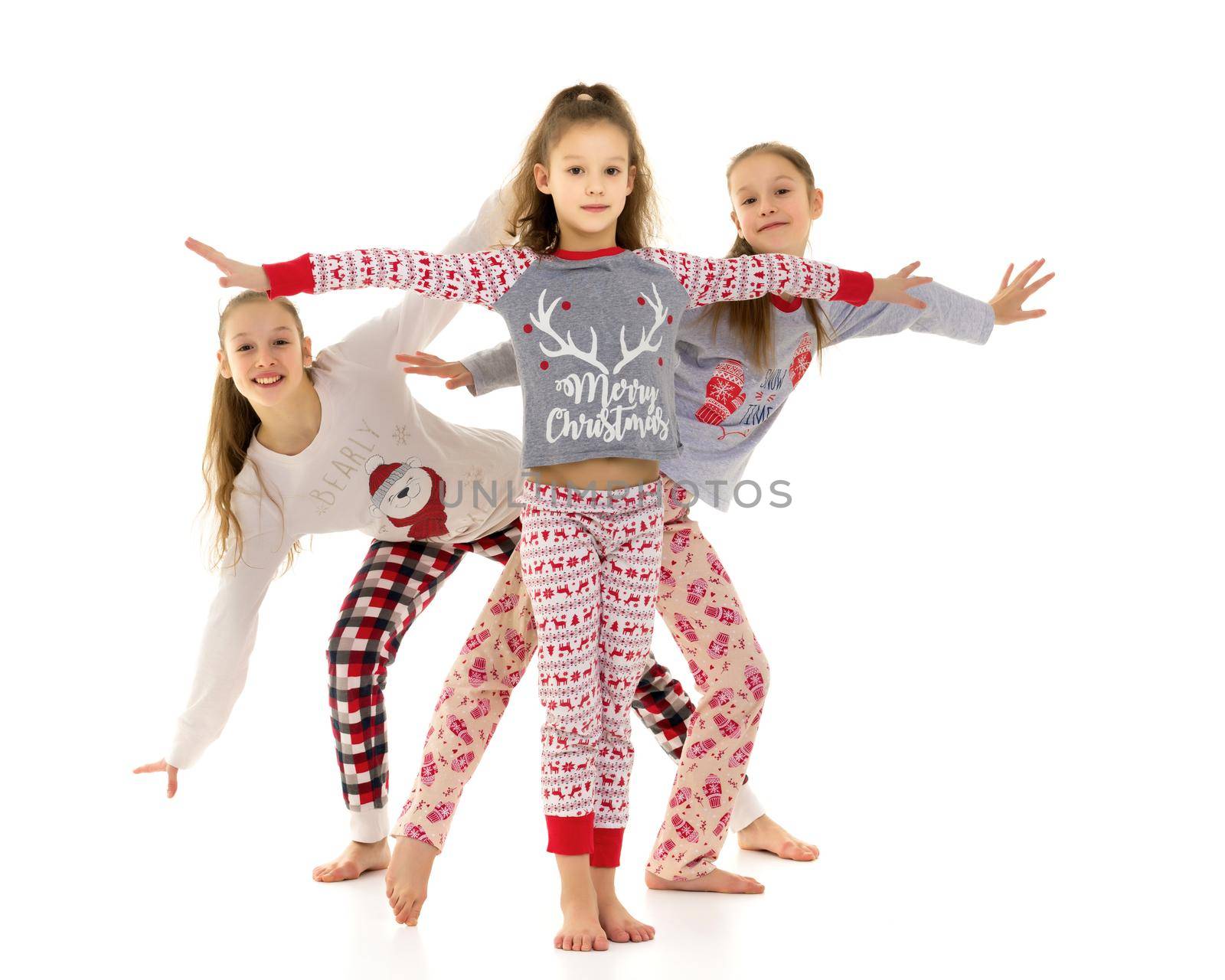 The company of cheerful little girls in the studio on a white background. The concept of youth and beauty. Isolated on white background