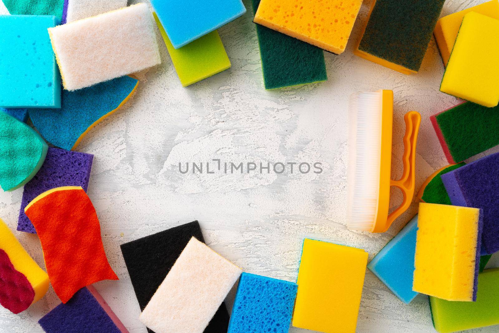 Pile of colorful cleaning sponges on gray background, top view