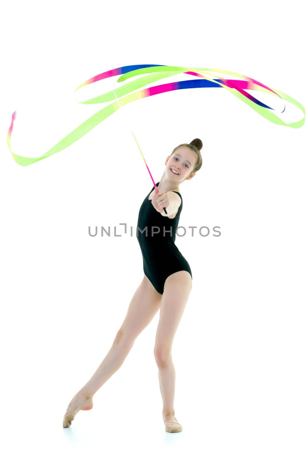 Girl gymnast performs exercises with tape. by kolesnikov_studio