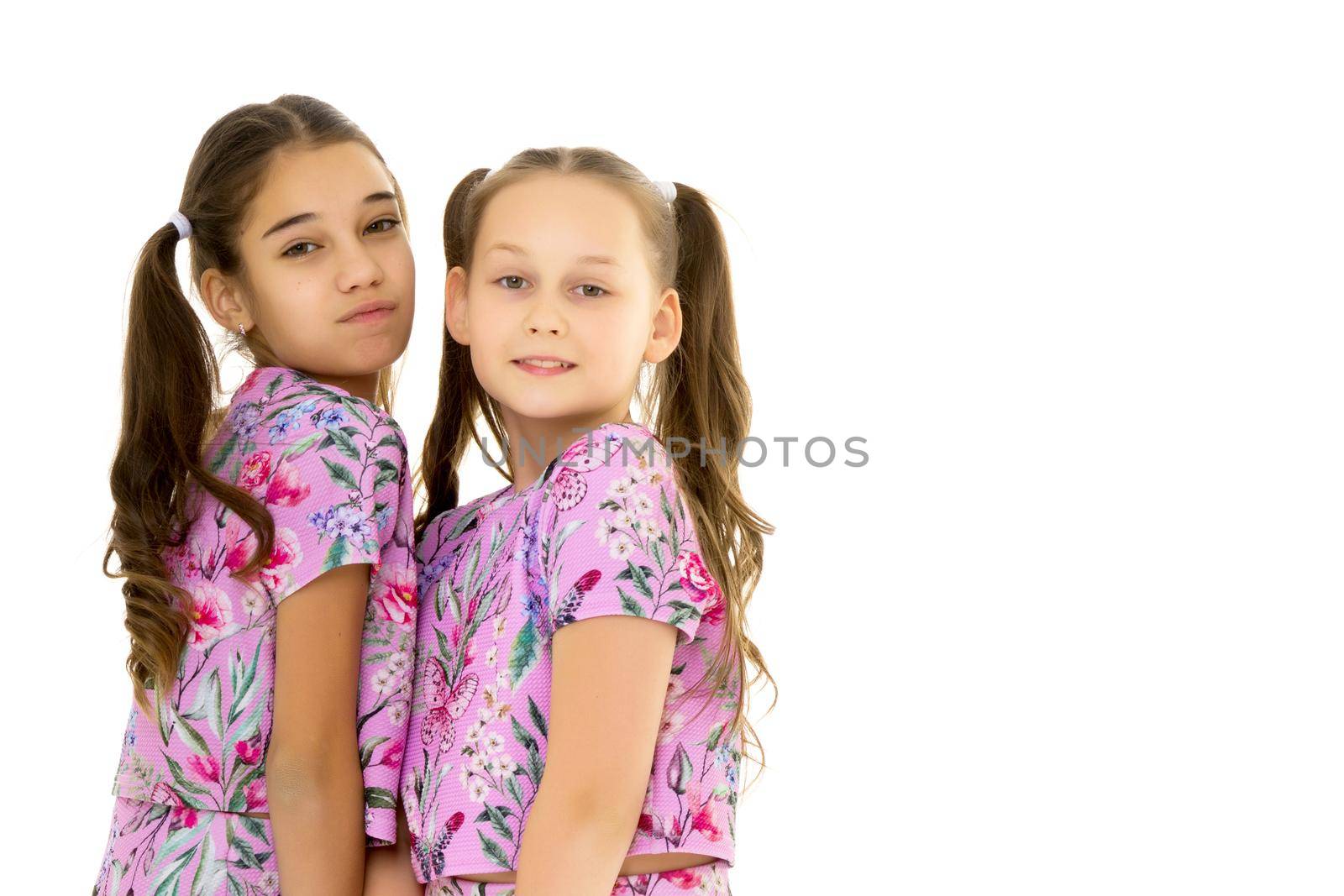 Two cute little girls close-up.Isolated on white background. by kolesnikov_studio
