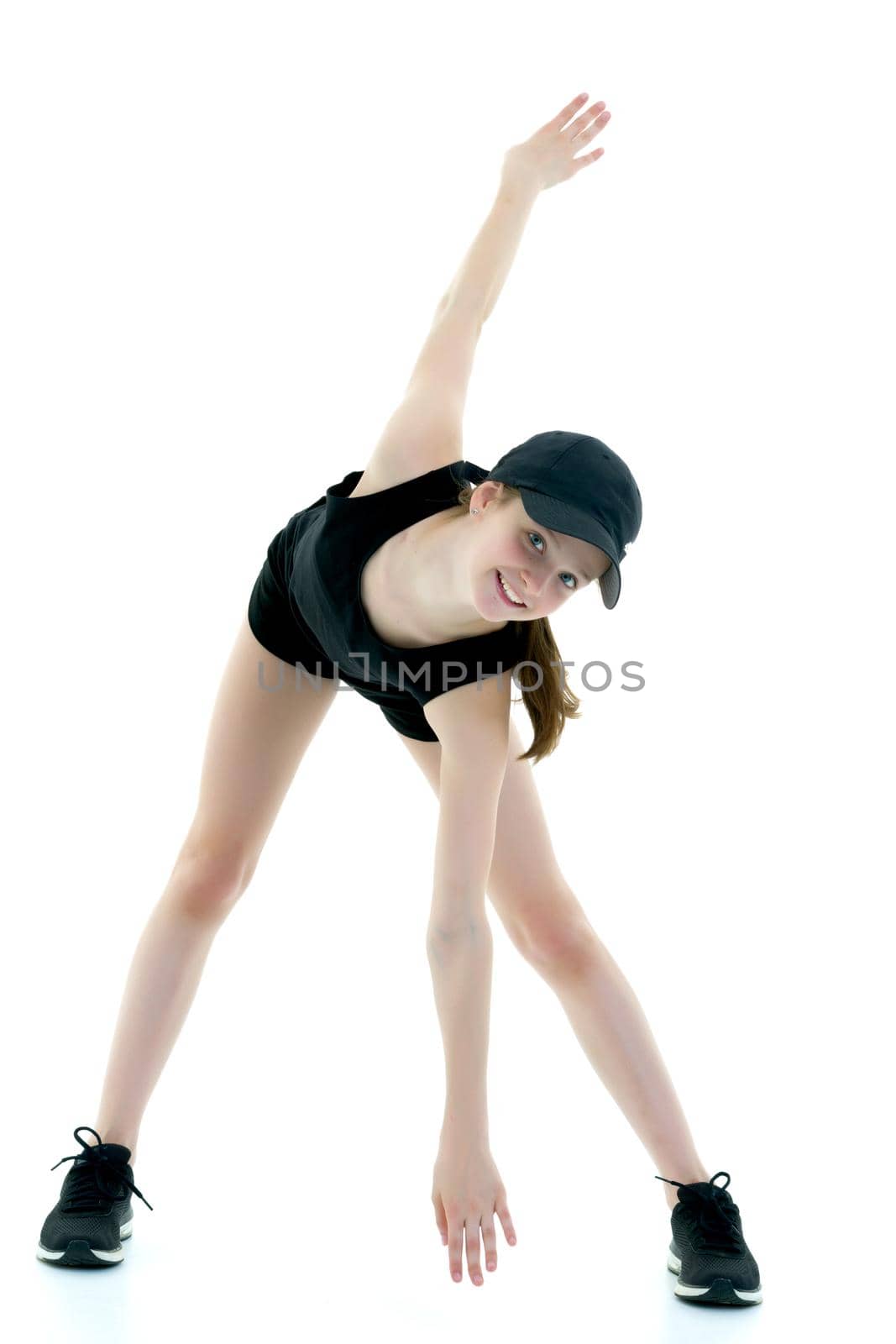 A teenage girl is engaged in fitness. She performs various exercises. The concept of childhood, sport, a healthy lifestyle. Isolated on white background.