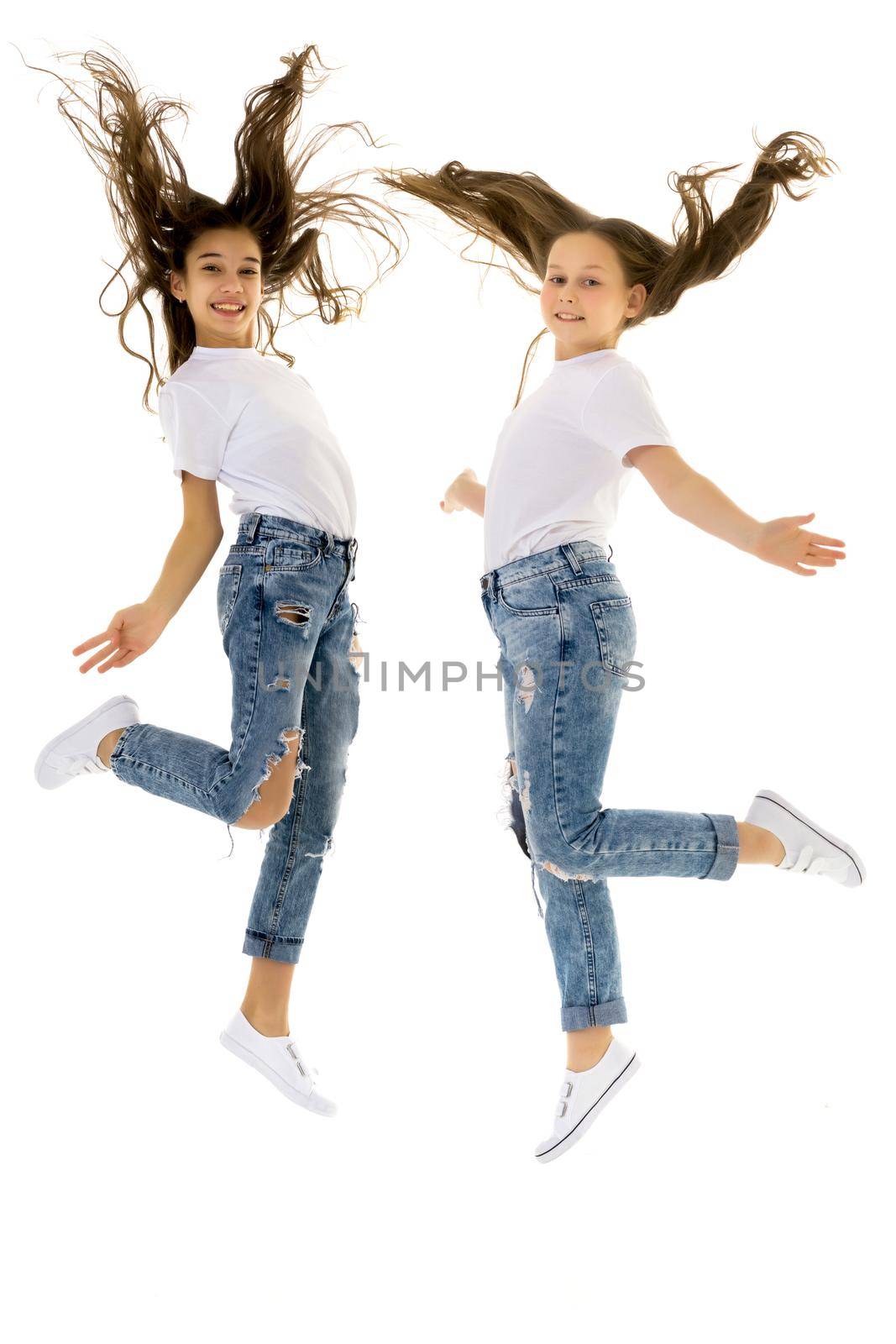 Two happy children jumping at once on a white background by kolesnikov_studio