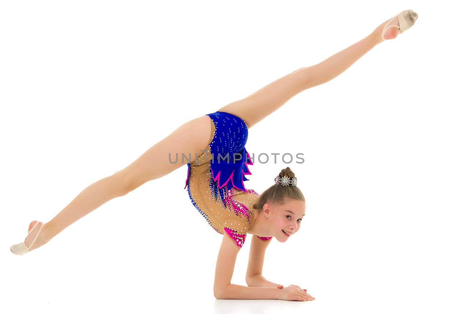 A girl gymnast performs an exercise stance on her forearms.The concept of childhood, sport, a healthy lifestyle. Isolated on white background.