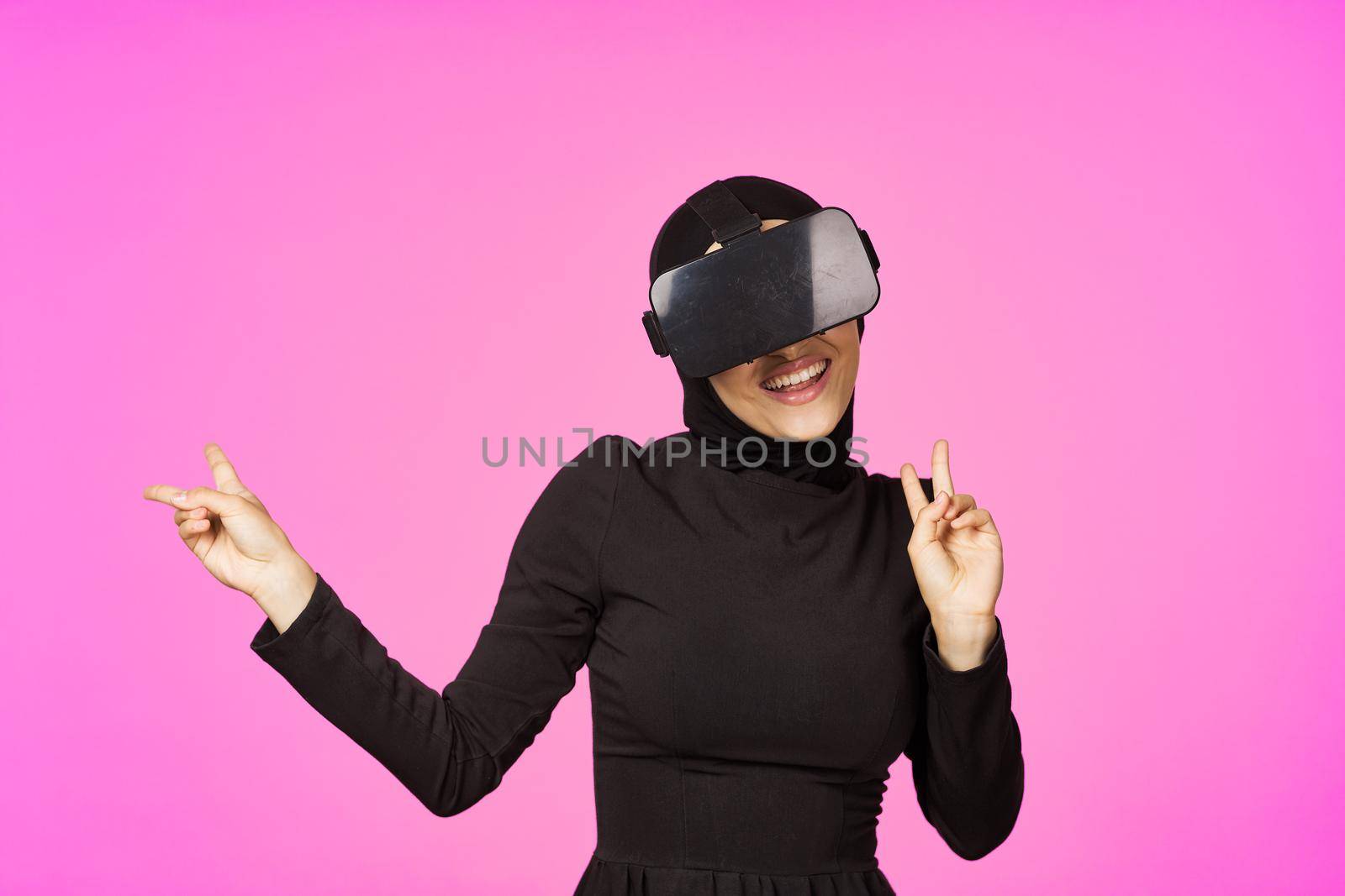 woman in black hijab glasses virtual reality technology movie watching. High quality photo