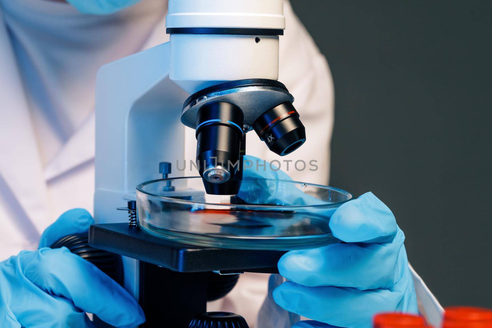 Close up photo of woman scientist working with microscope in laboratory