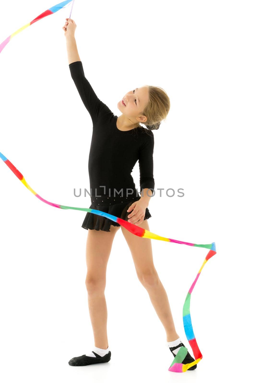 Girl gymnast performs exercises with tape. by kolesnikov_studio