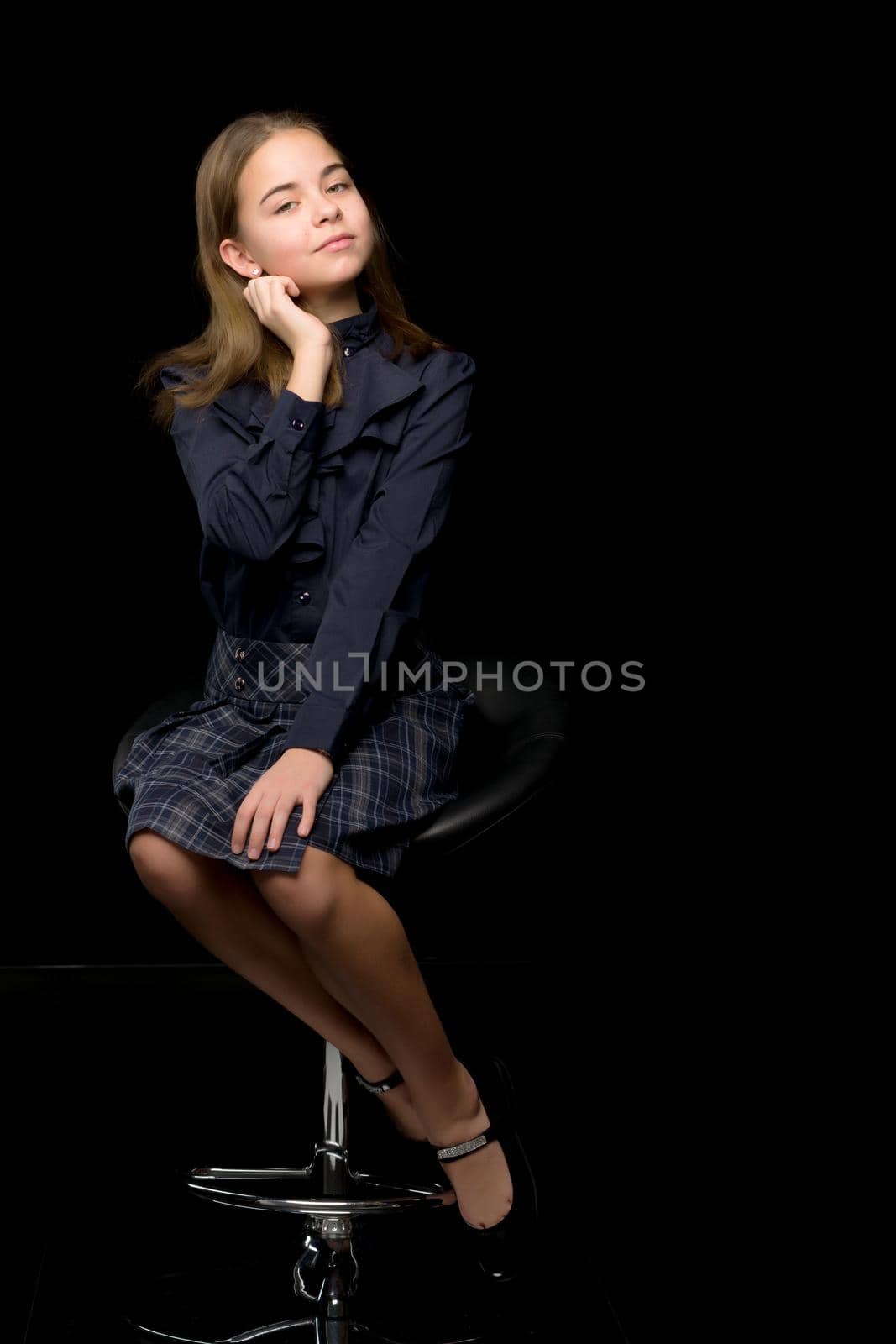 Front View Portrait of Adorable Girl in Stylish Dress Sitting on Chair. by kolesnikov_studio