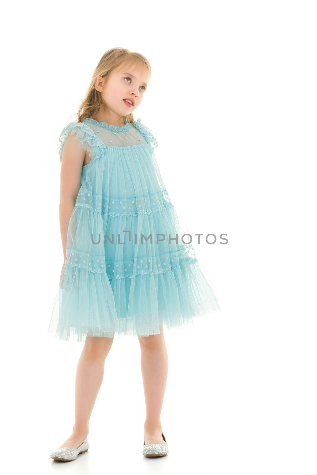 Little girl in a short denim dress. by kolesnikov_studio