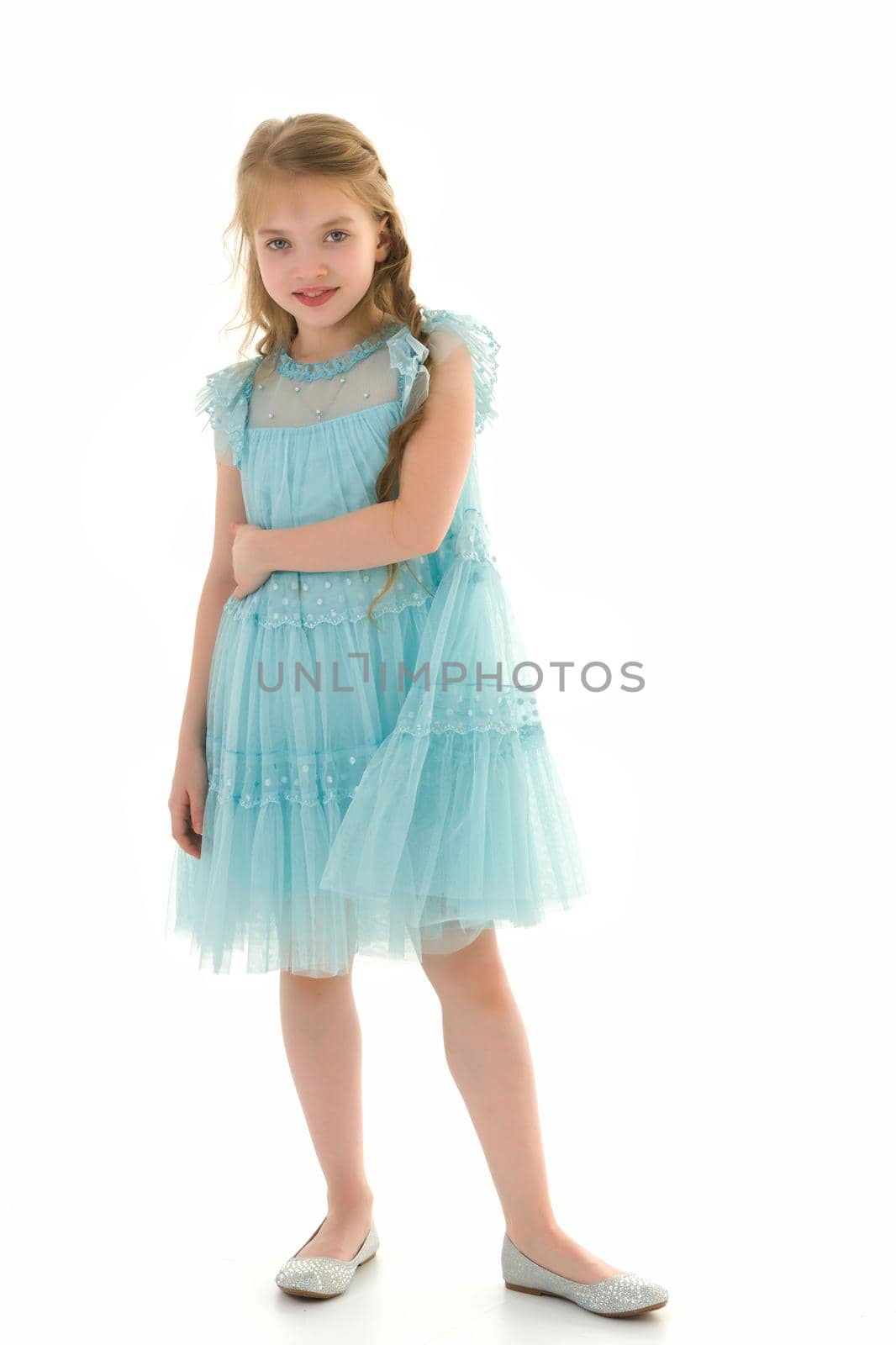 Charming little girl in a light summer dress. Concept of family vacation, happy childhood. In isolation.