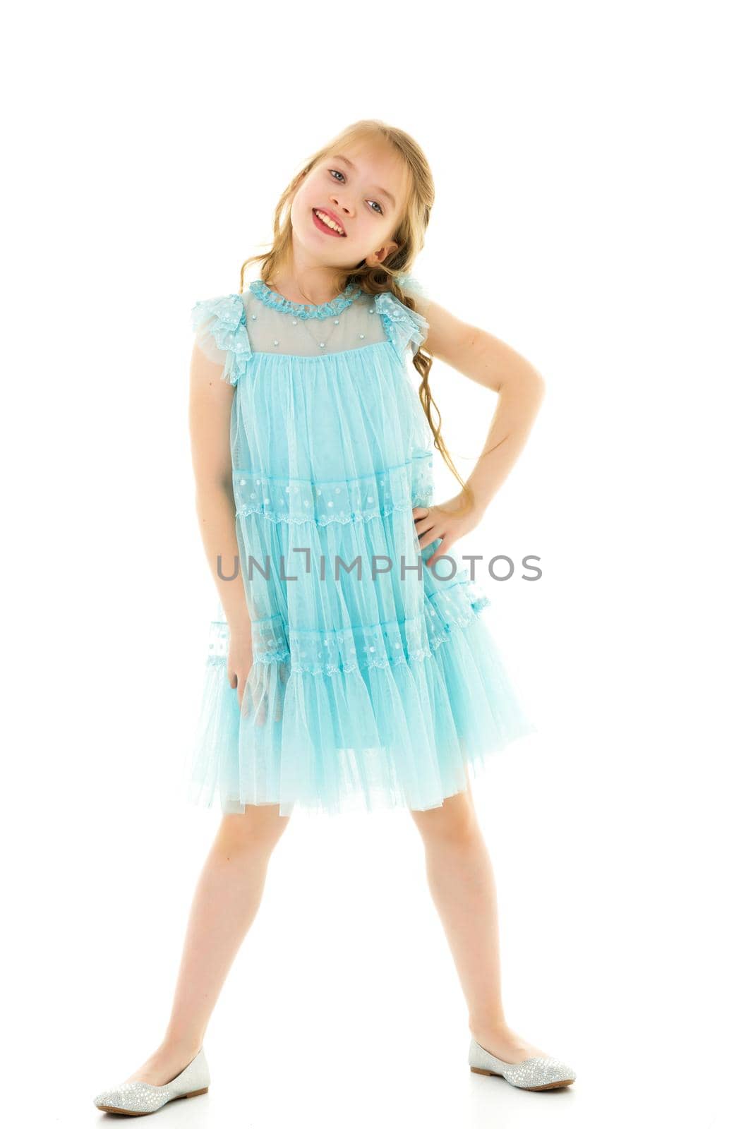 Charming little girl in a light summer dress. Concept of family vacation, happy childhood. In isolation.
