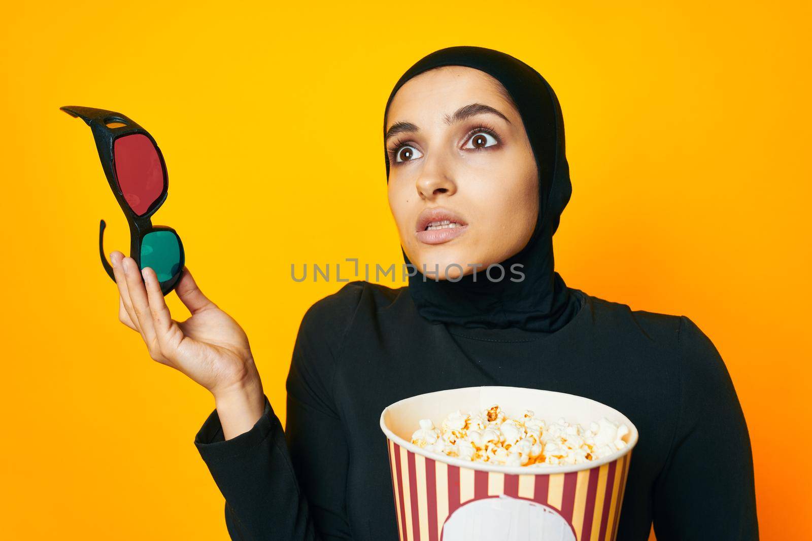 cheerful woman in black hijab popcorn 3D glasses cinema ethnicity model by Vichizh