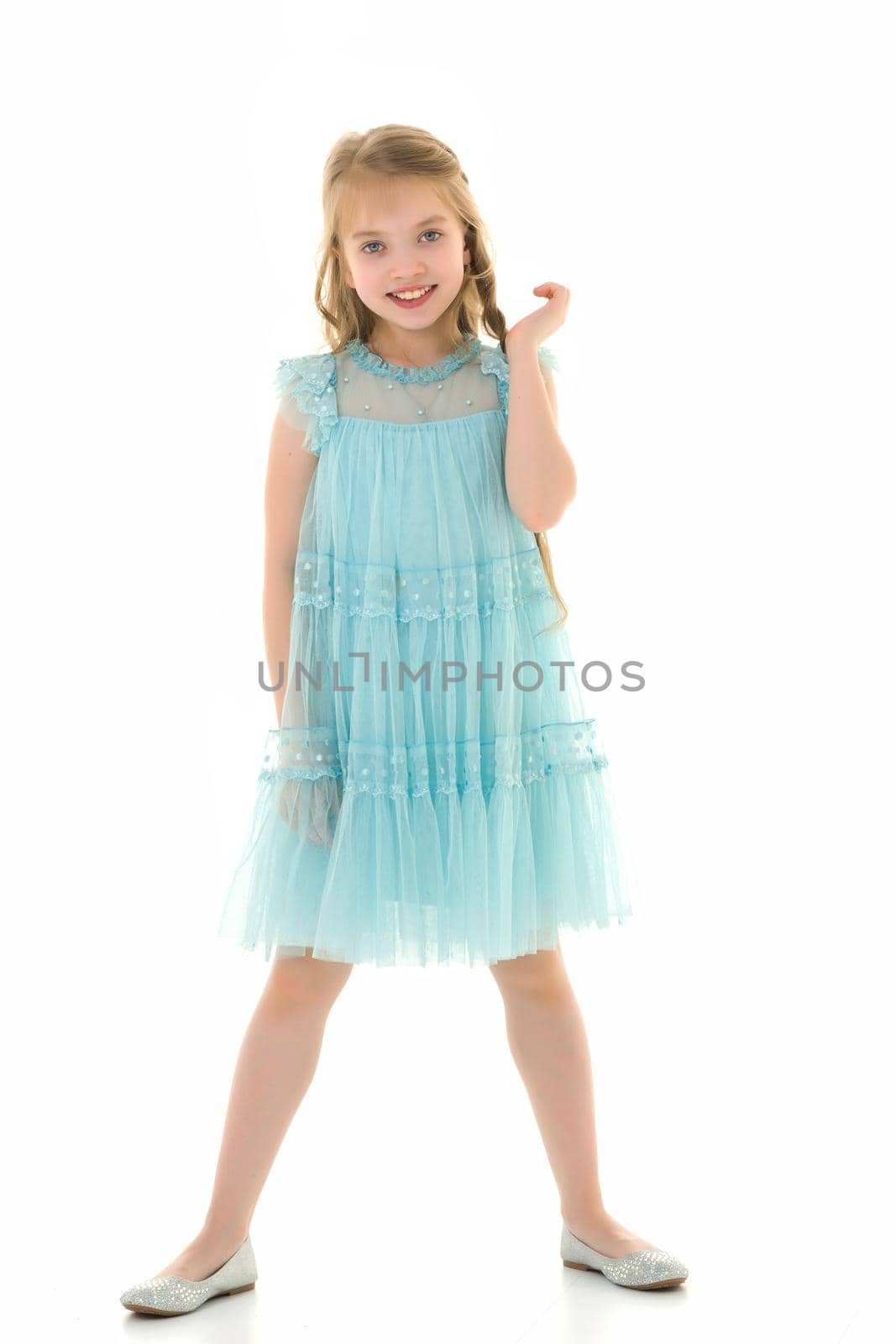 Charming little girl in a light summer dress. Concept of family vacation, happy childhood. In isolation.