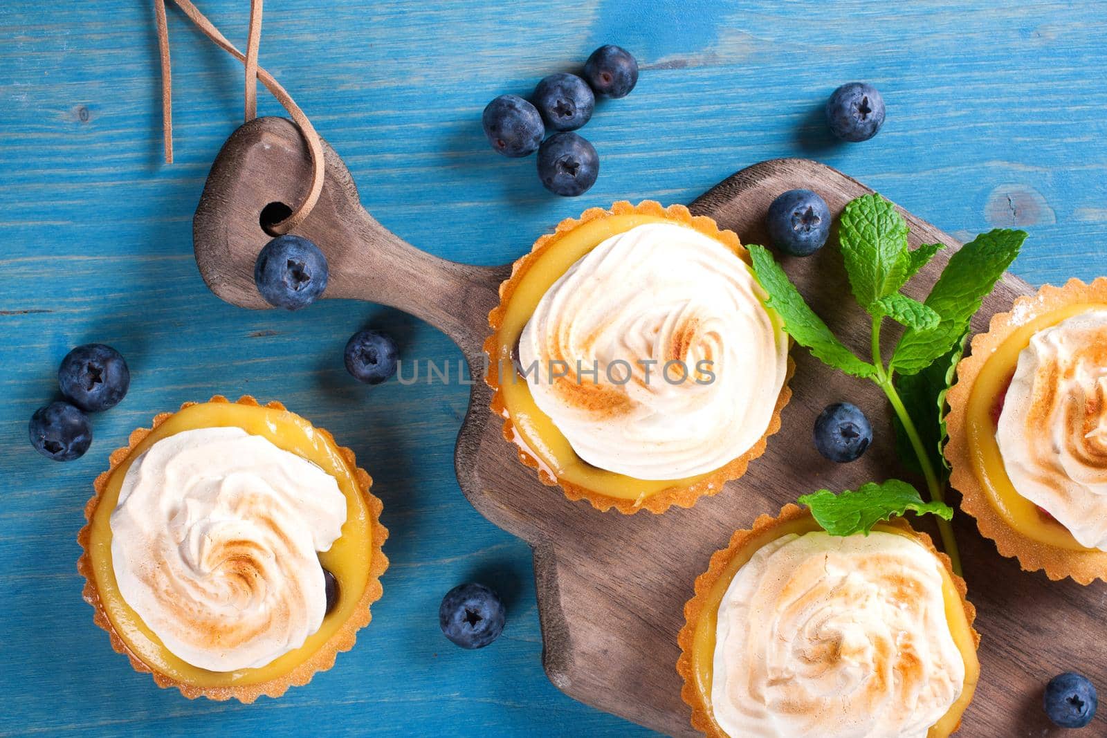 Mini lime curd tartlets with meringue. Holiday concept. Top view.