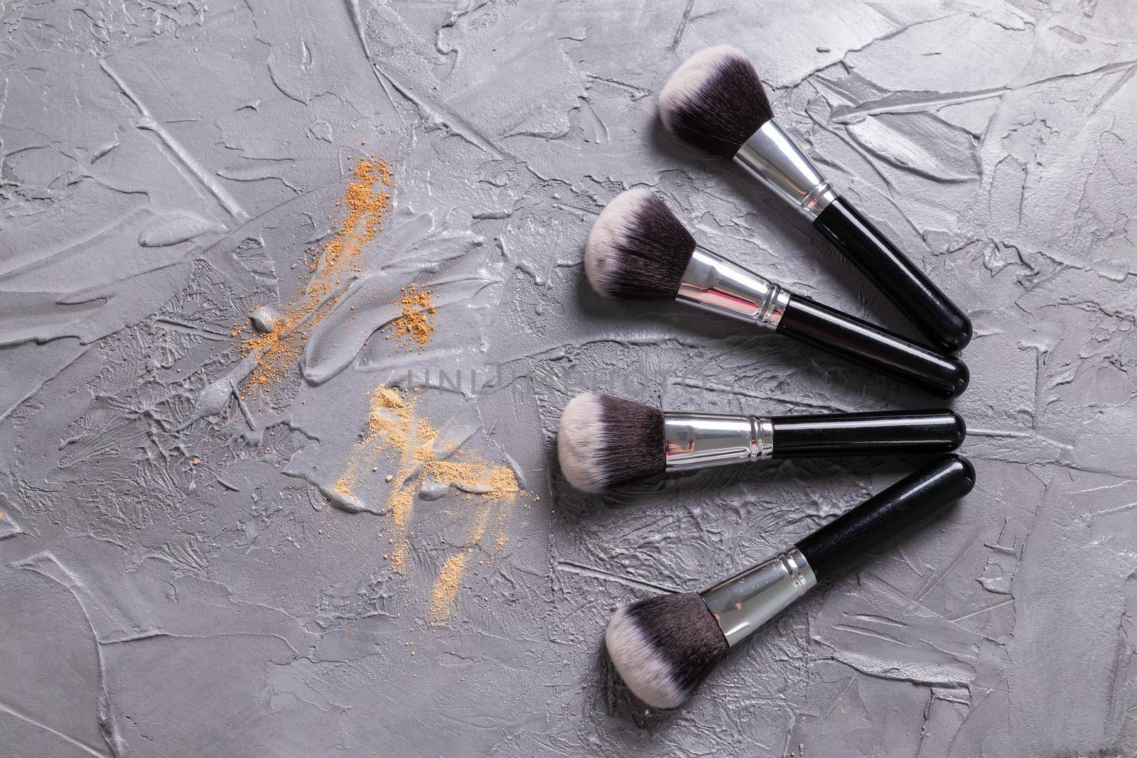 Mineral powder for face and a brushes for powder and visage on grey background. Eco friendly and organic cosmetics. by Satura86