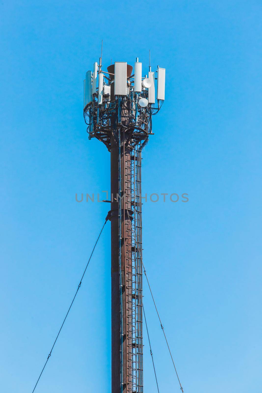 Antenna signal radio high mobile communication network on the background of blue sky.