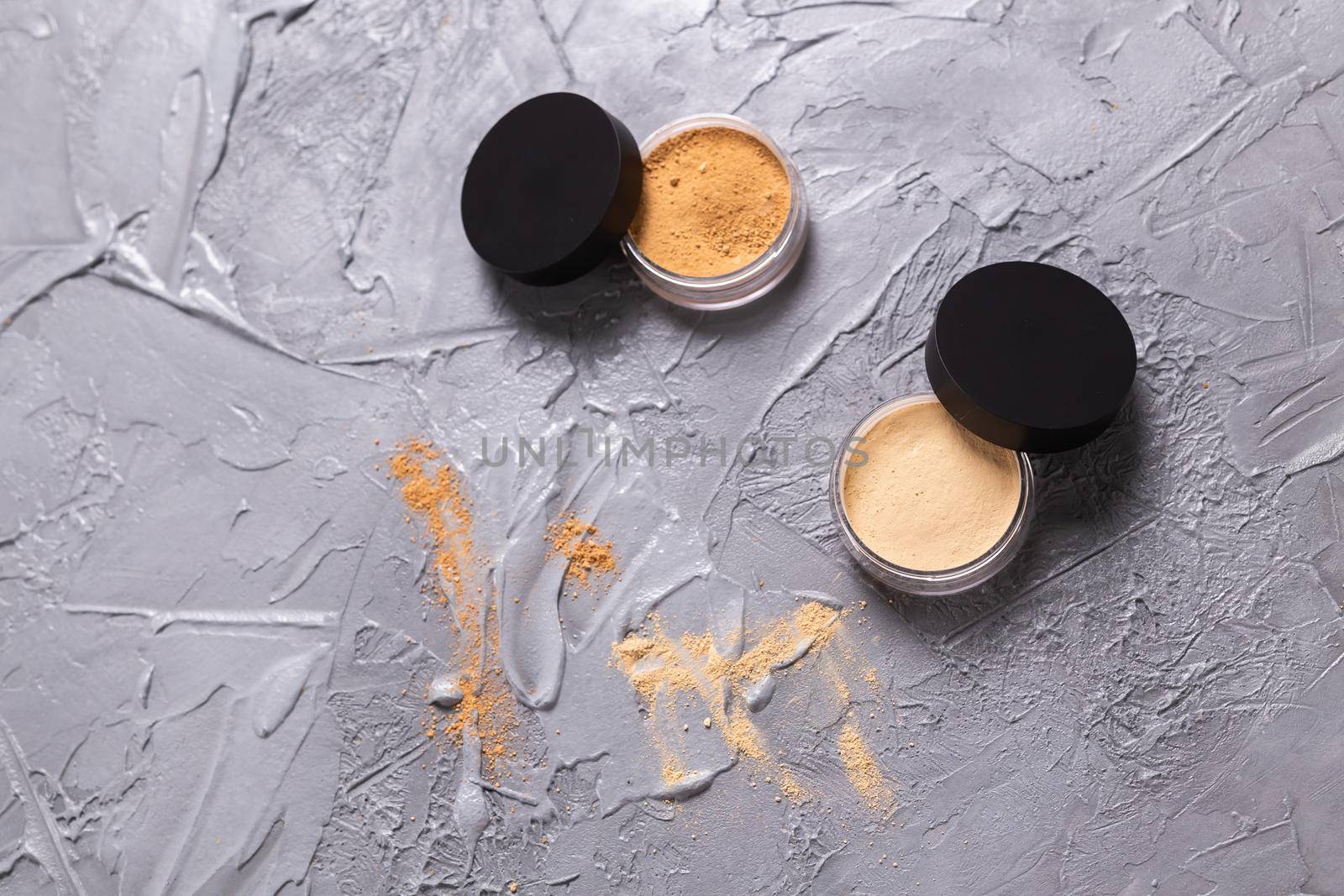Mineral powder for face and a brushes for powder and visage on grey background. Eco friendly and organic cosmetics. by Satura86
