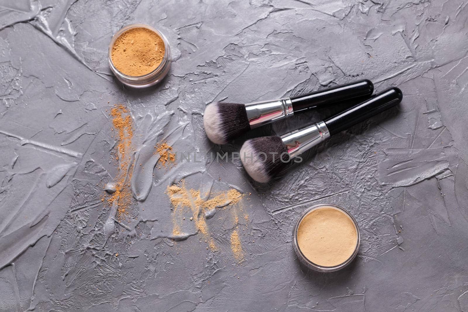 Mineral powder of different colors with a brushes for make-up on wooden background, top view by Satura86
