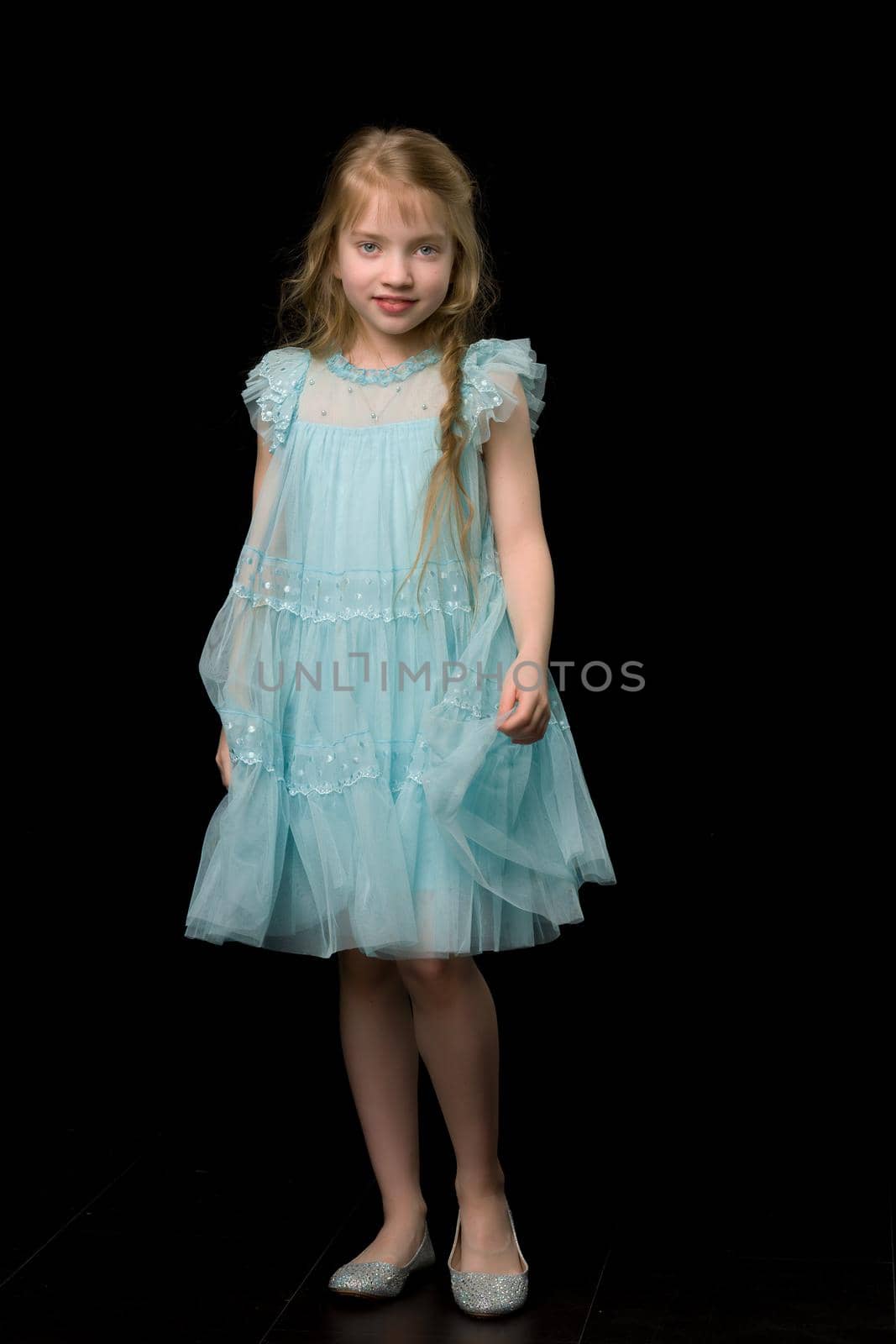 Charming little girl in a light summer dress. Concept of family vacation, happy childhood. In isolation.