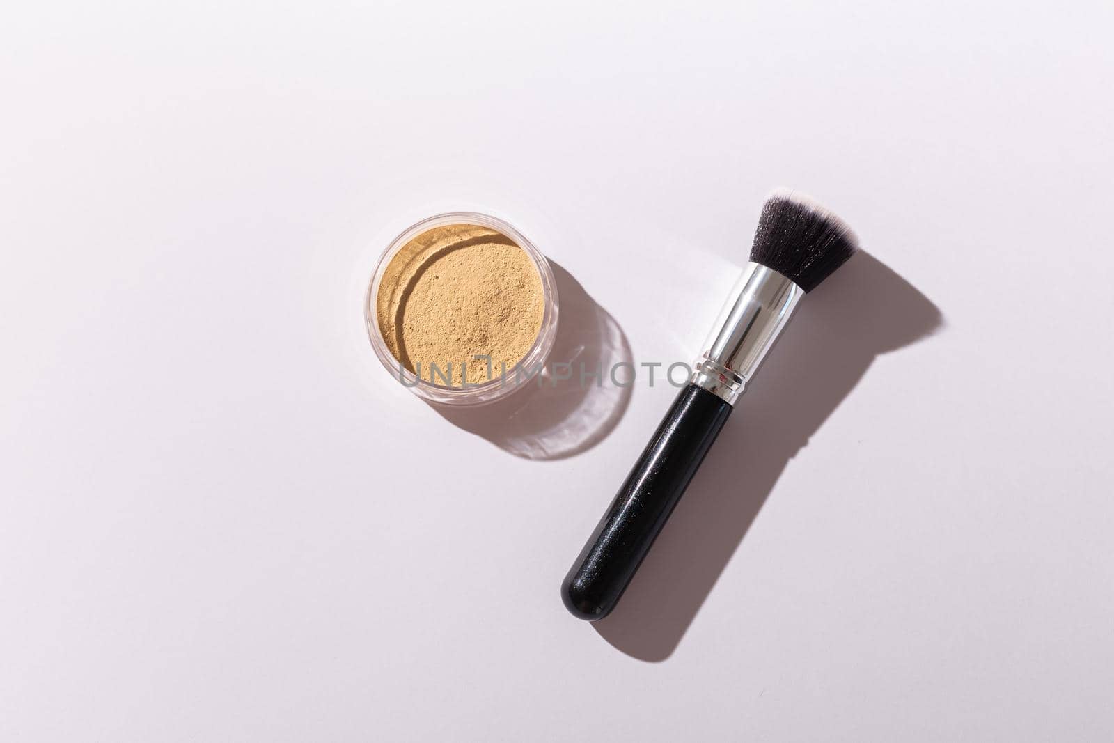 Mineral face powder and brush. Eco-friendly and organic beauty products.