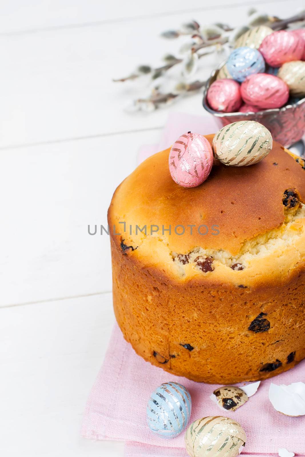 Easter bread and colorful eggs on white background