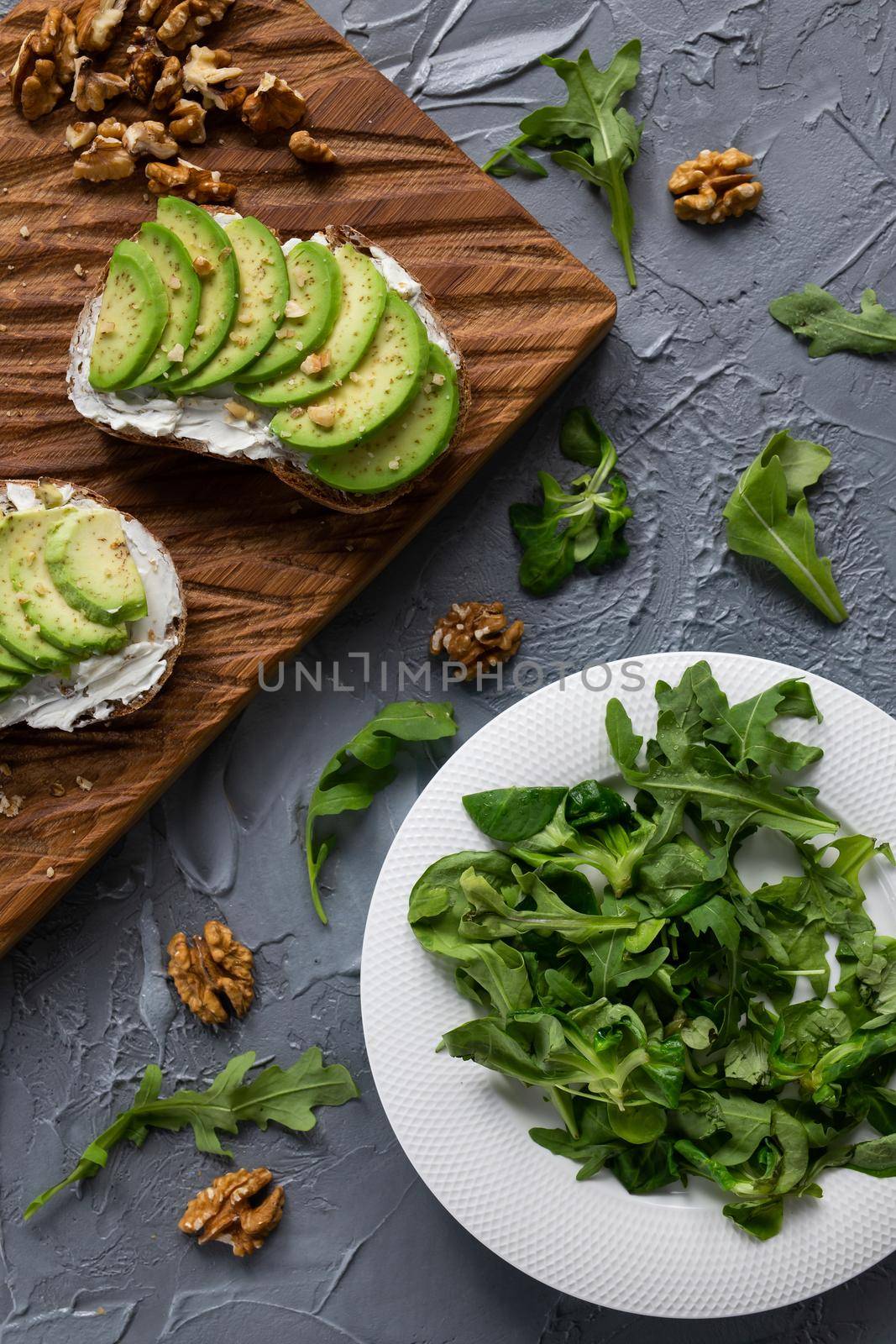 sliced avocado on toast bread with nuts by Satura86