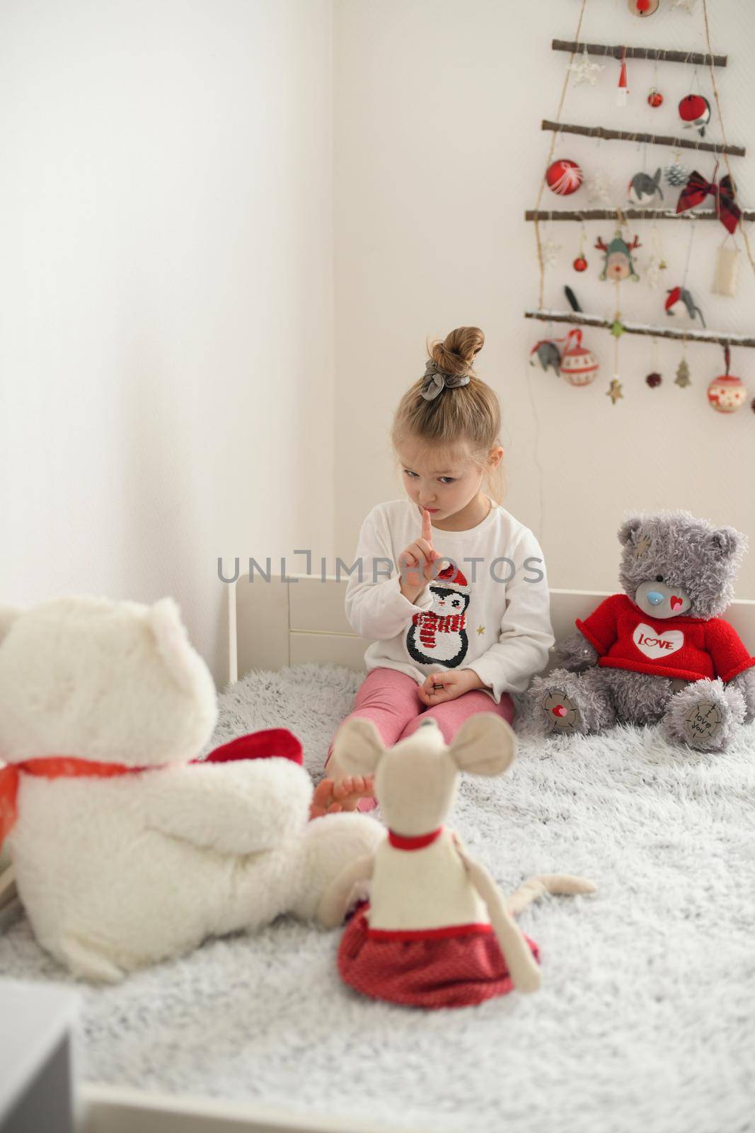 A girl playing in a room with the plush toys