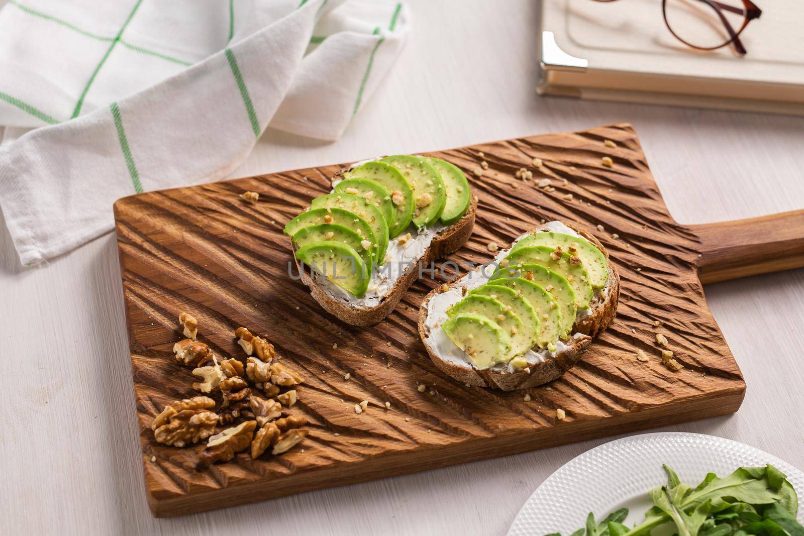 Avocado sandwich on dark rye bread made with fresh sliced avocados from above