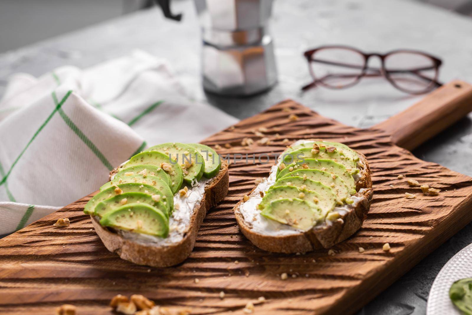 Avocado sandwich on dark rye bread made with fresh sliced avocados from above