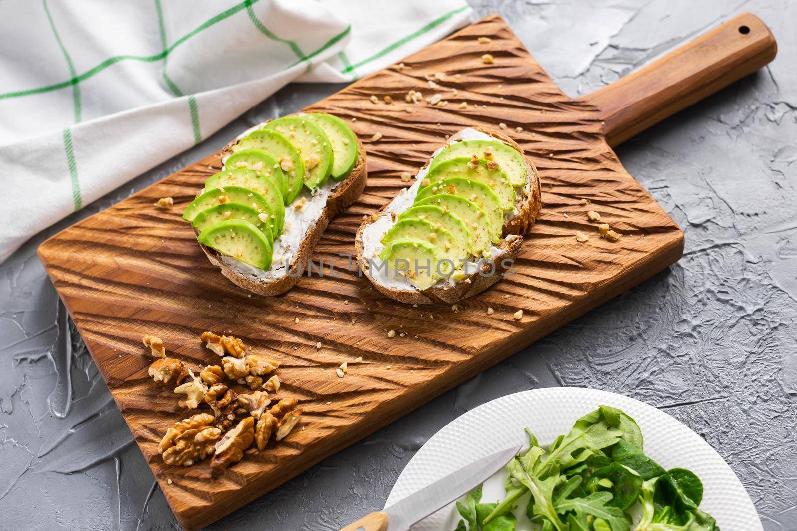 Avocado sandwich on dark rye bread made with fresh sliced avocados from above