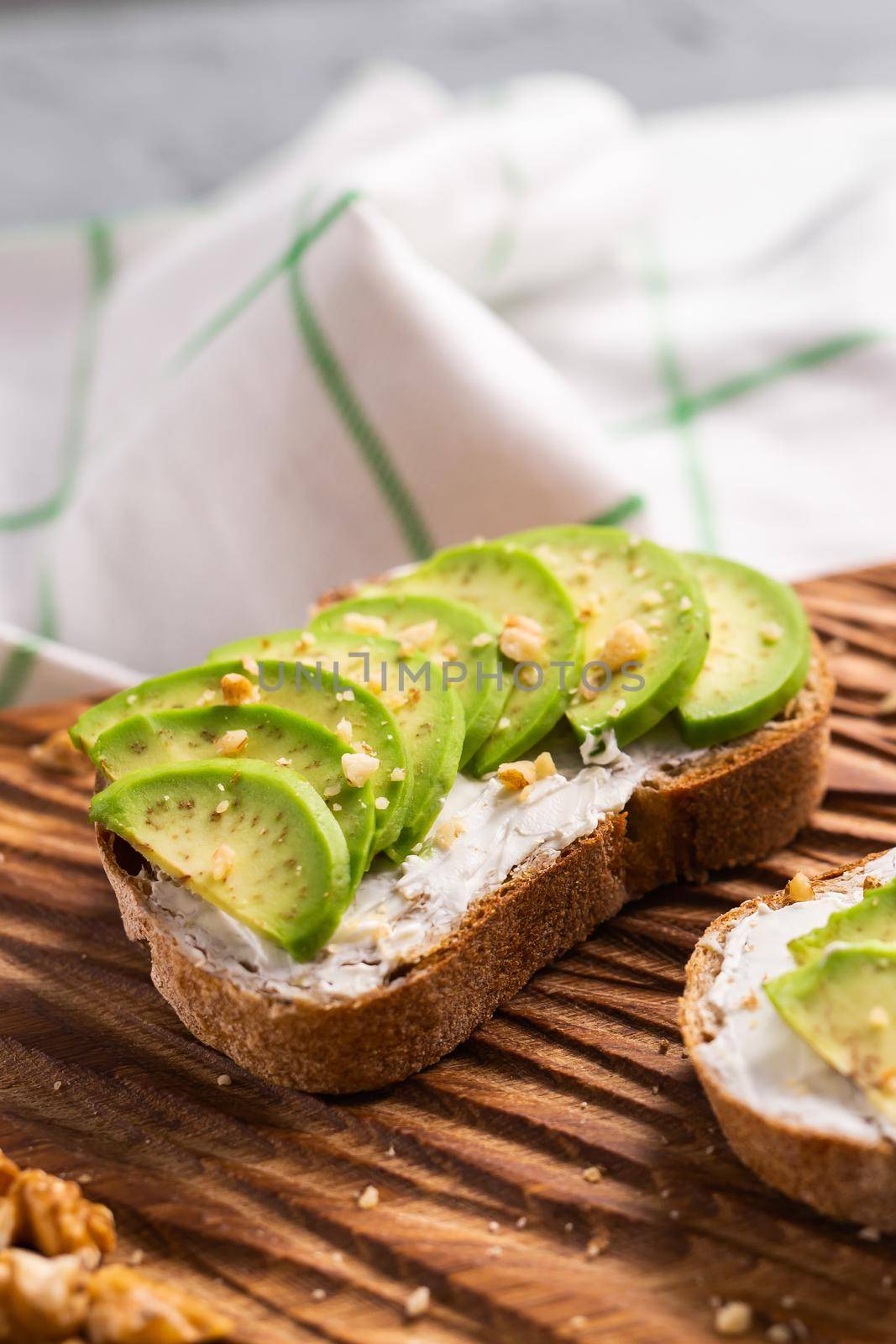 Avocado sandwich on dark rye bread made with fresh sliced avocados from above