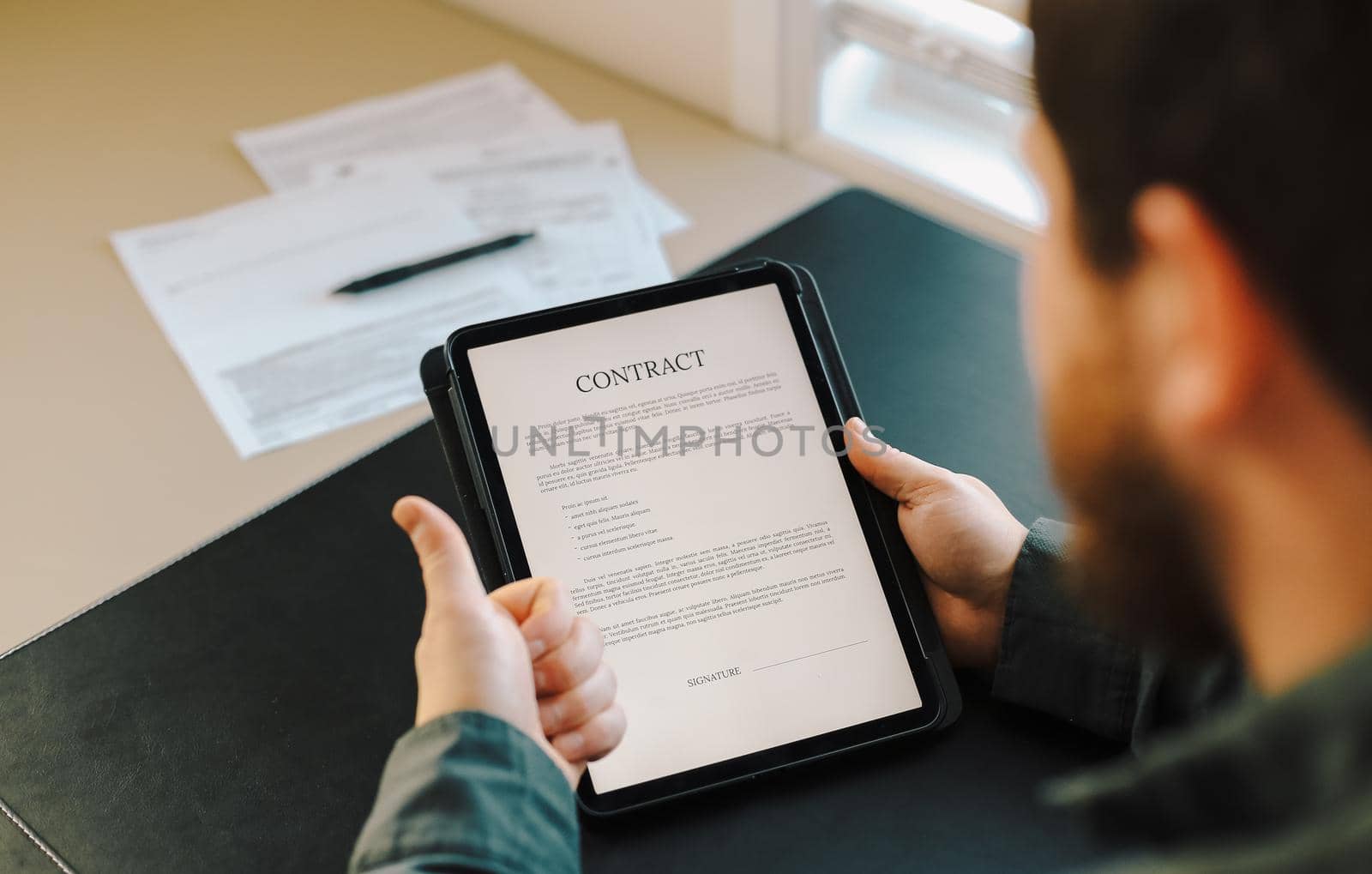 Lawyer reading contract template on tablet and showing thumbs up. by sisterspro
